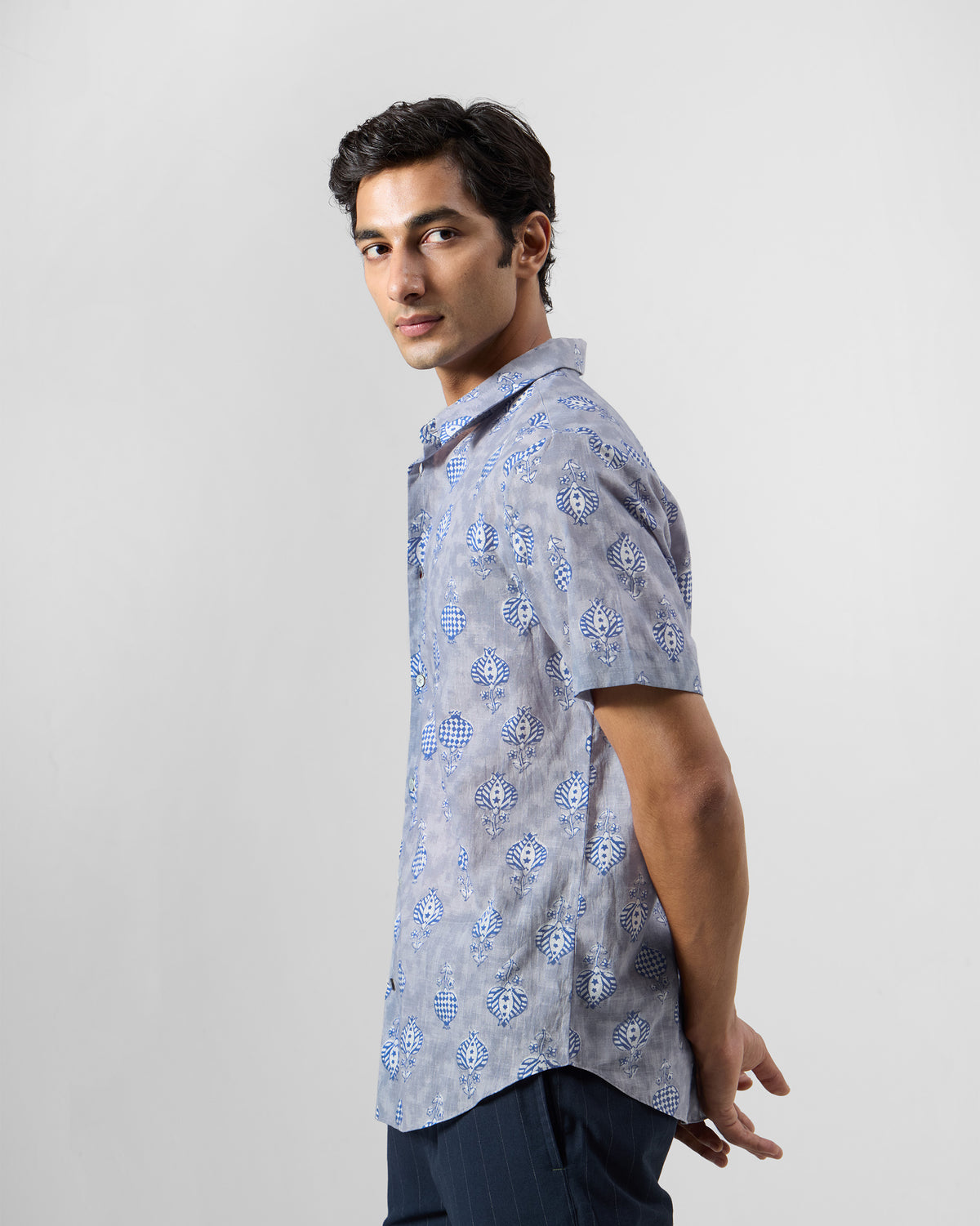 Side view of a light blue Ganga Shirt with blue block-printed motifs.