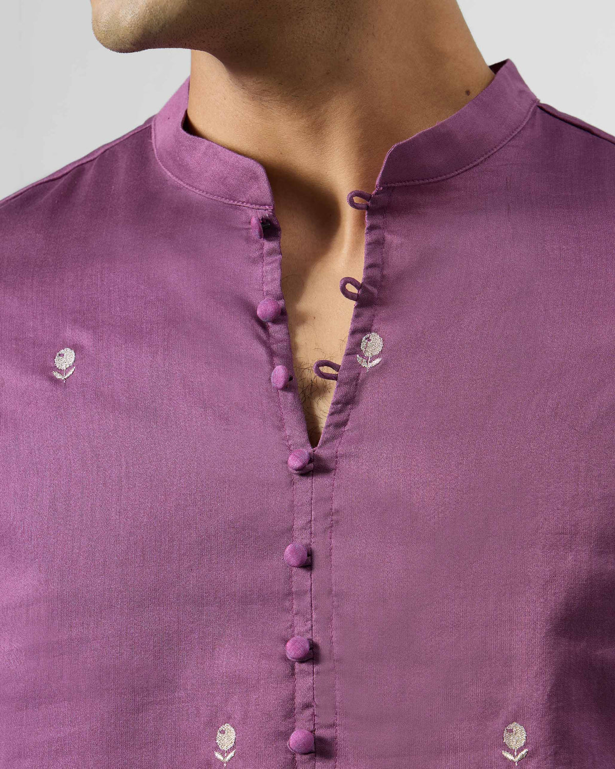 Close-up of a jamun pink Zenith Kurta with potli buttons and floral motifs.