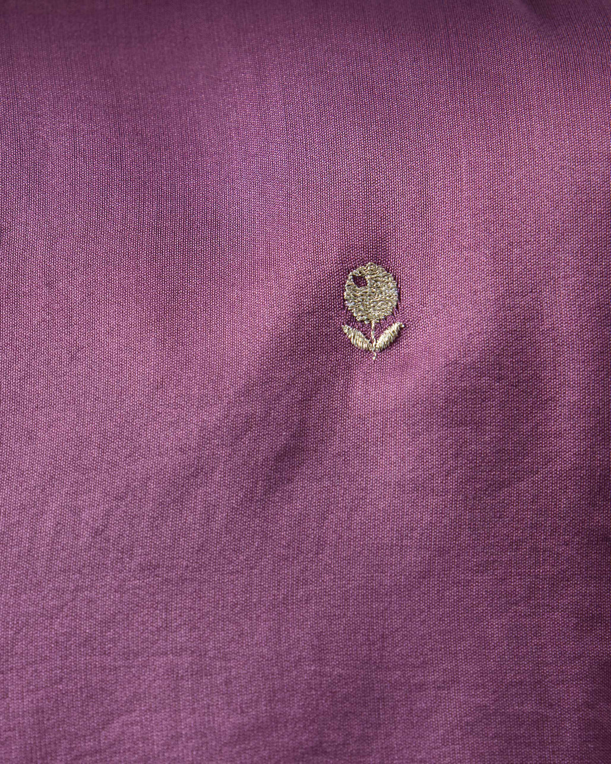 Close-up of a gold embroidered motif on a jamun pink Zenith Kurta.