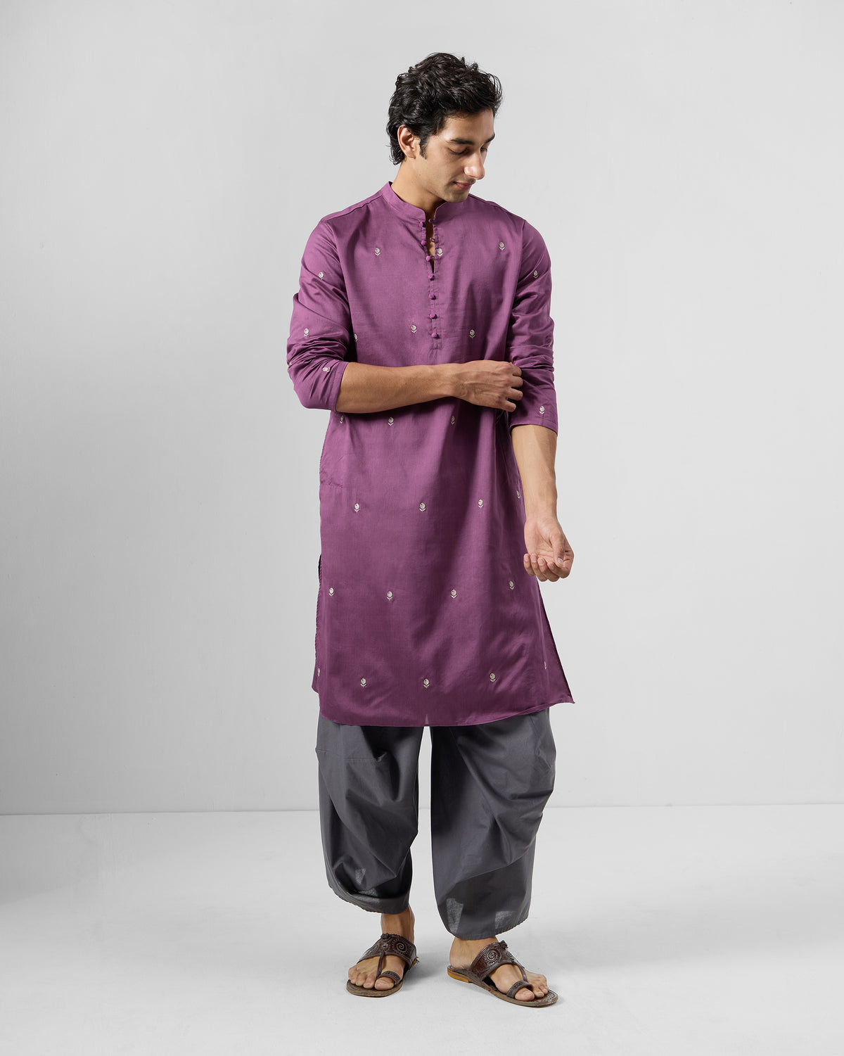 Person wearing a jamun pink Zenith Kurta with scattered white motifs.