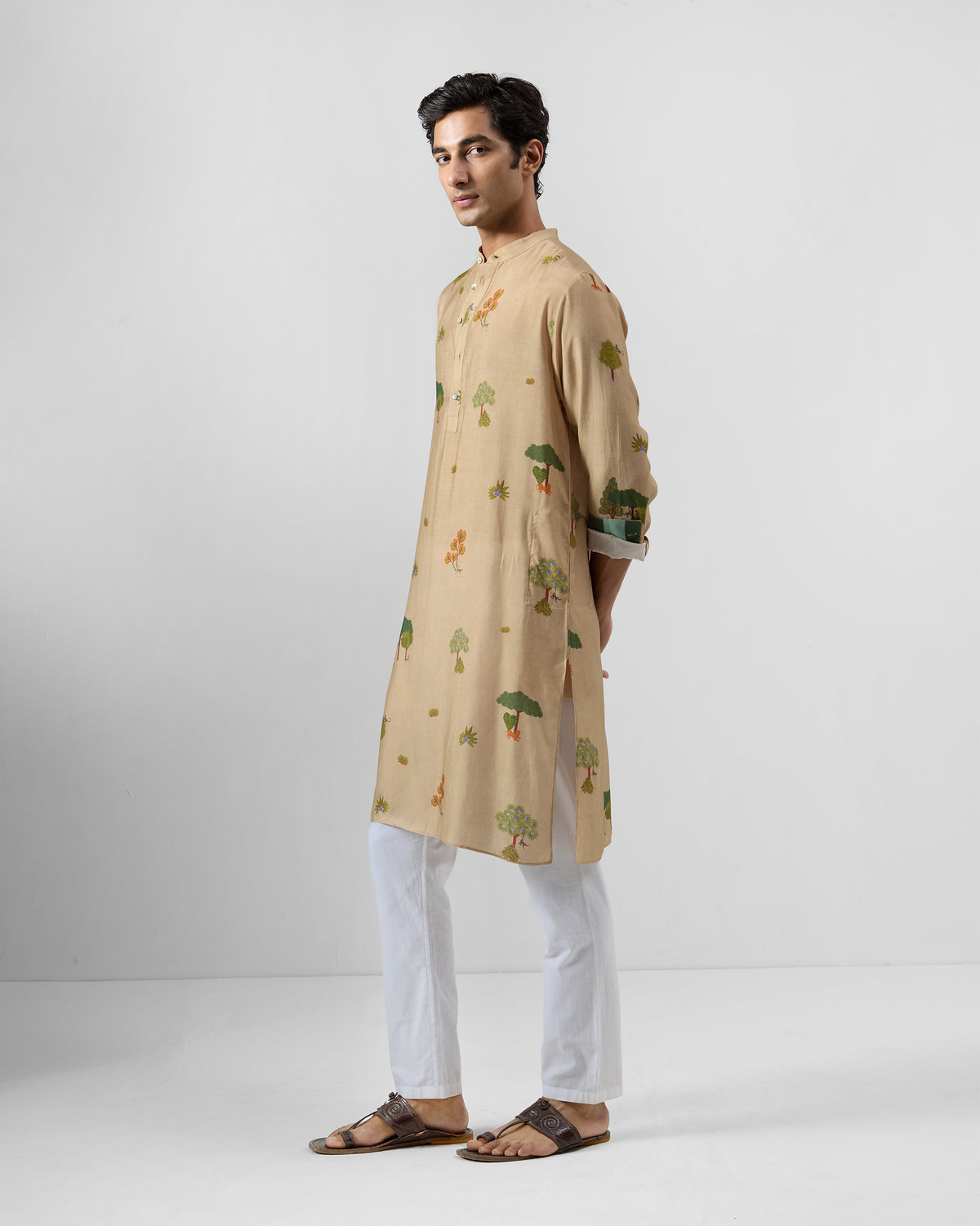 Side view of a beige Bageecha kurta with a tree print.