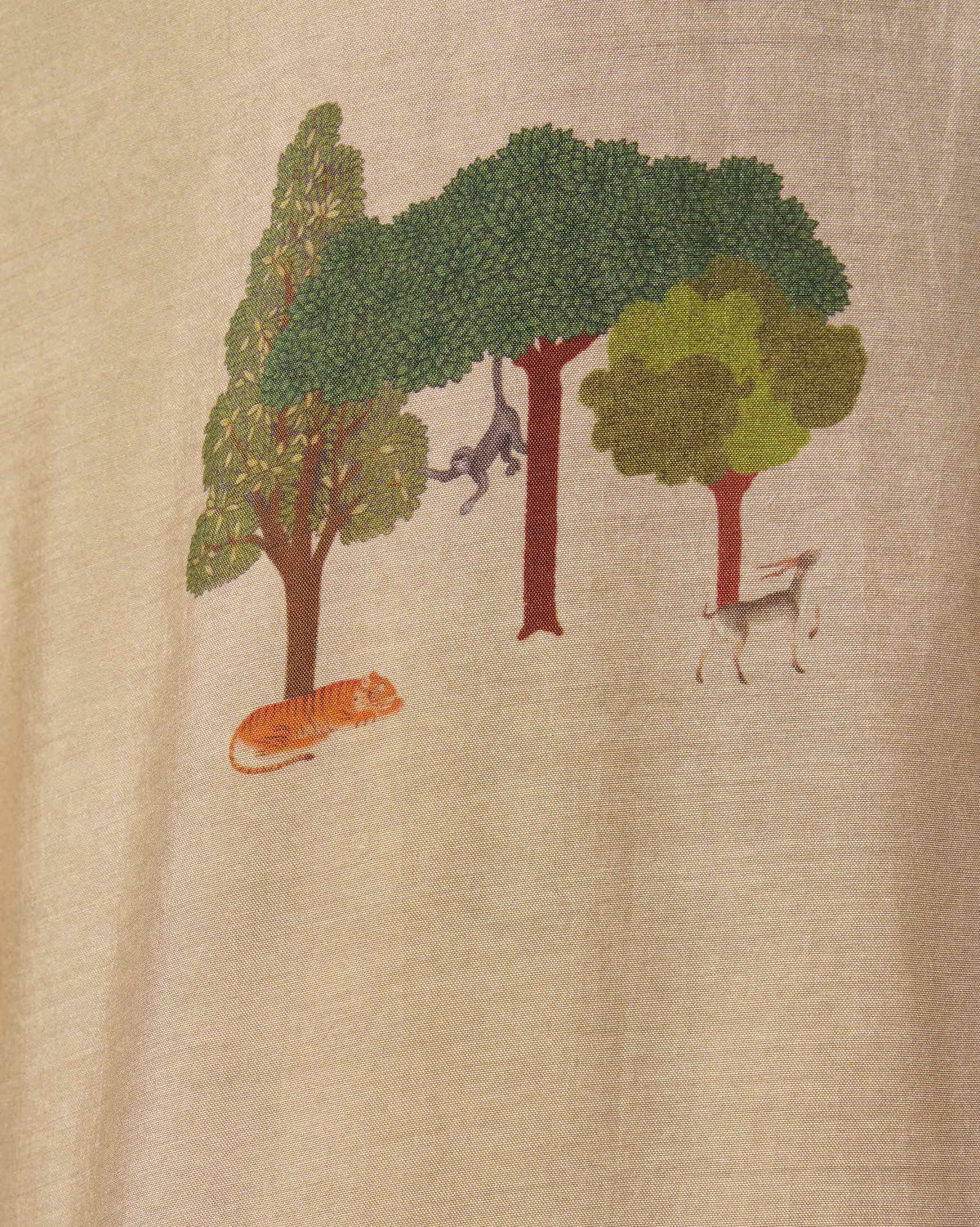 Close-up of tiger and monkey motifs on a beige Bageecha kurta.