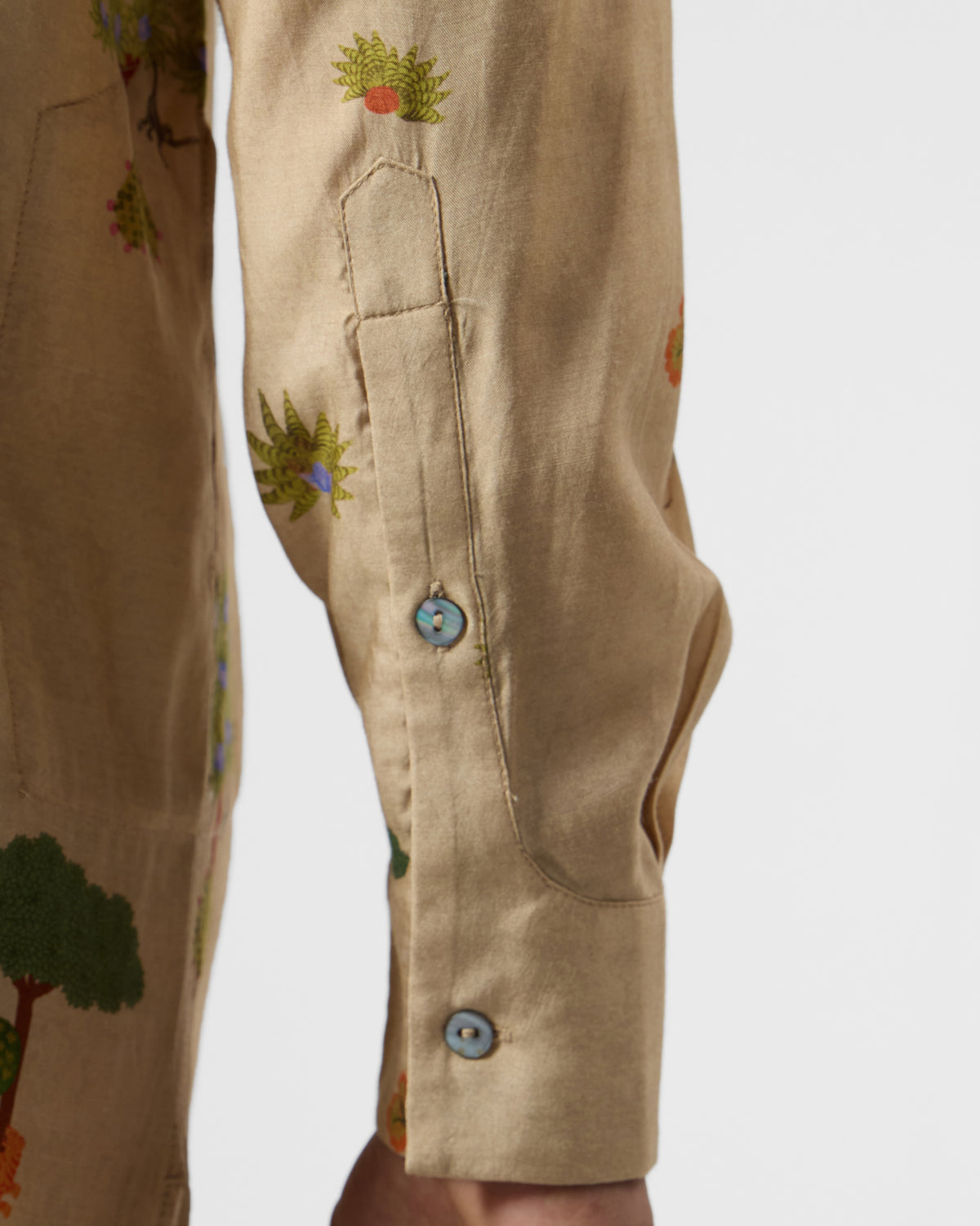 Close-up of a beige Bageecha kurta cuff with tree motifs.