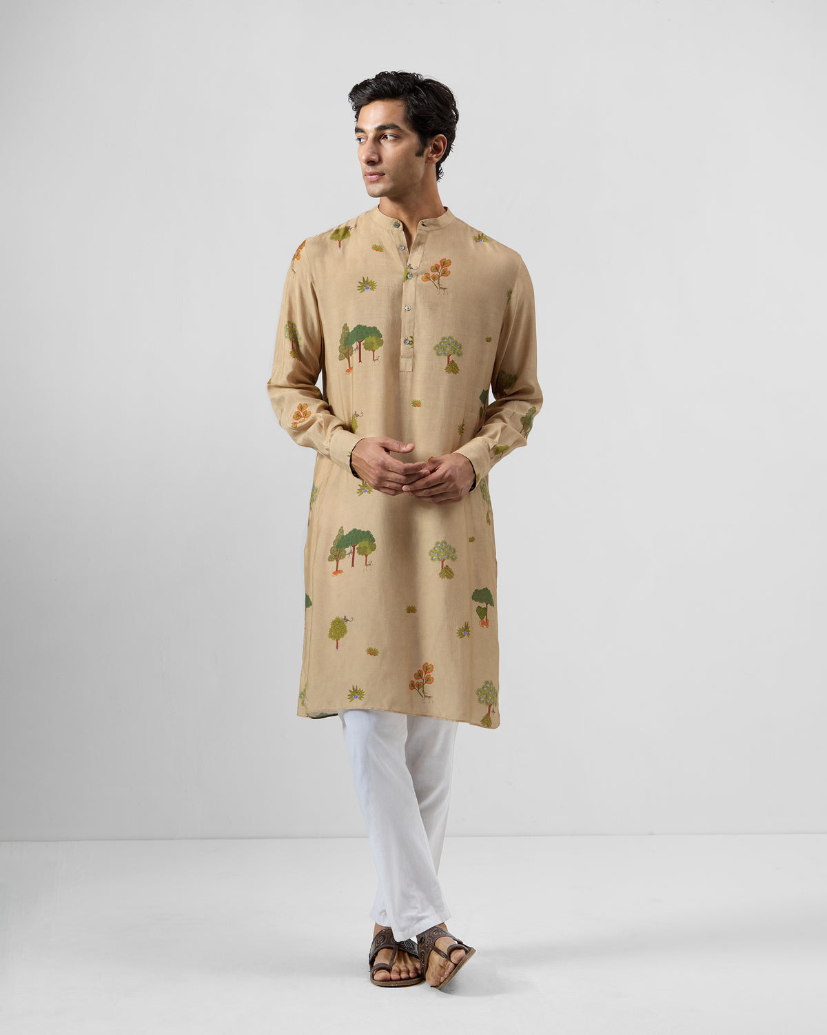 Person wearing a beige Bageecha kurta with a tree print.