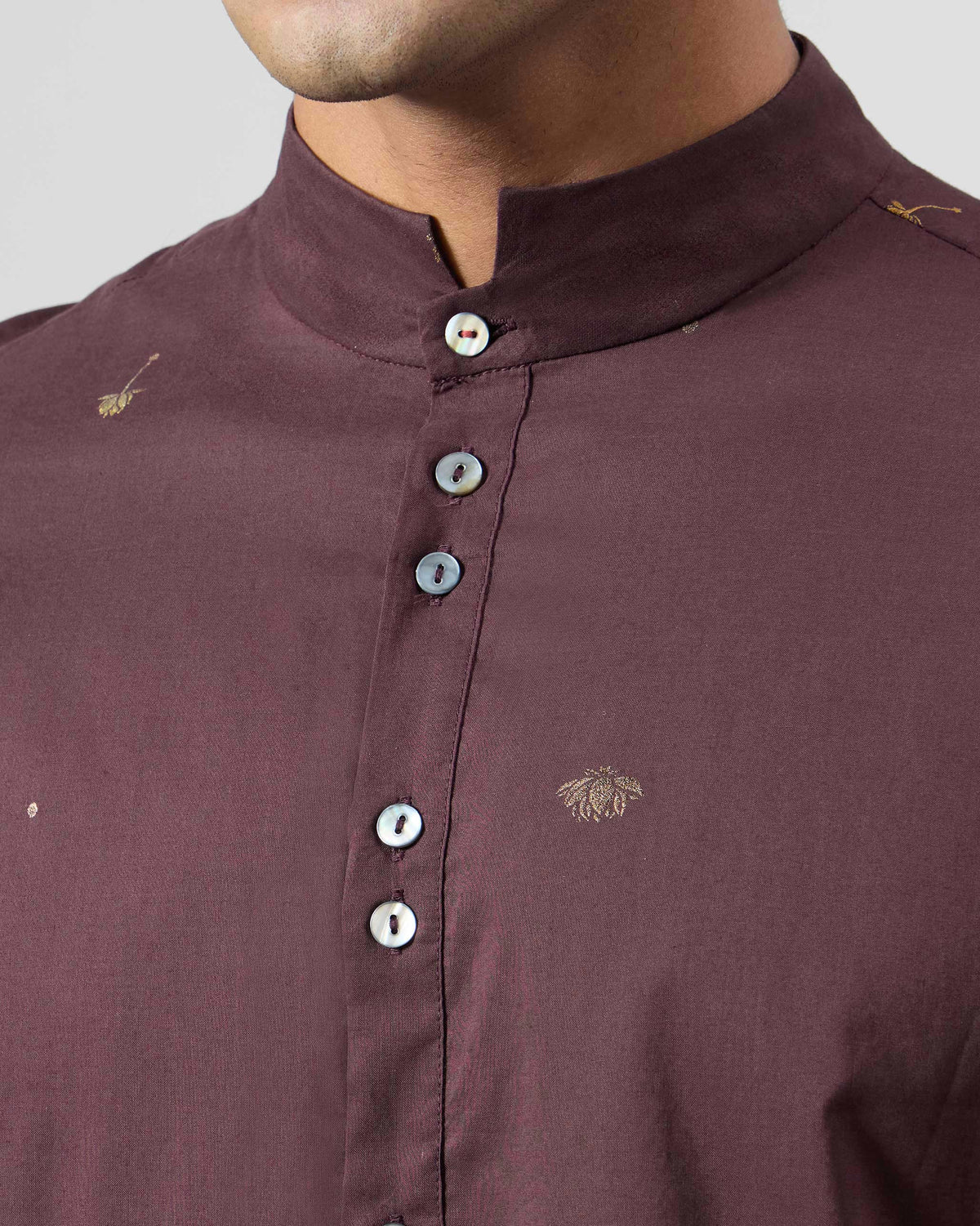 Close-up of a wine Rey Kurta showing the band collar and gold foil motifs.