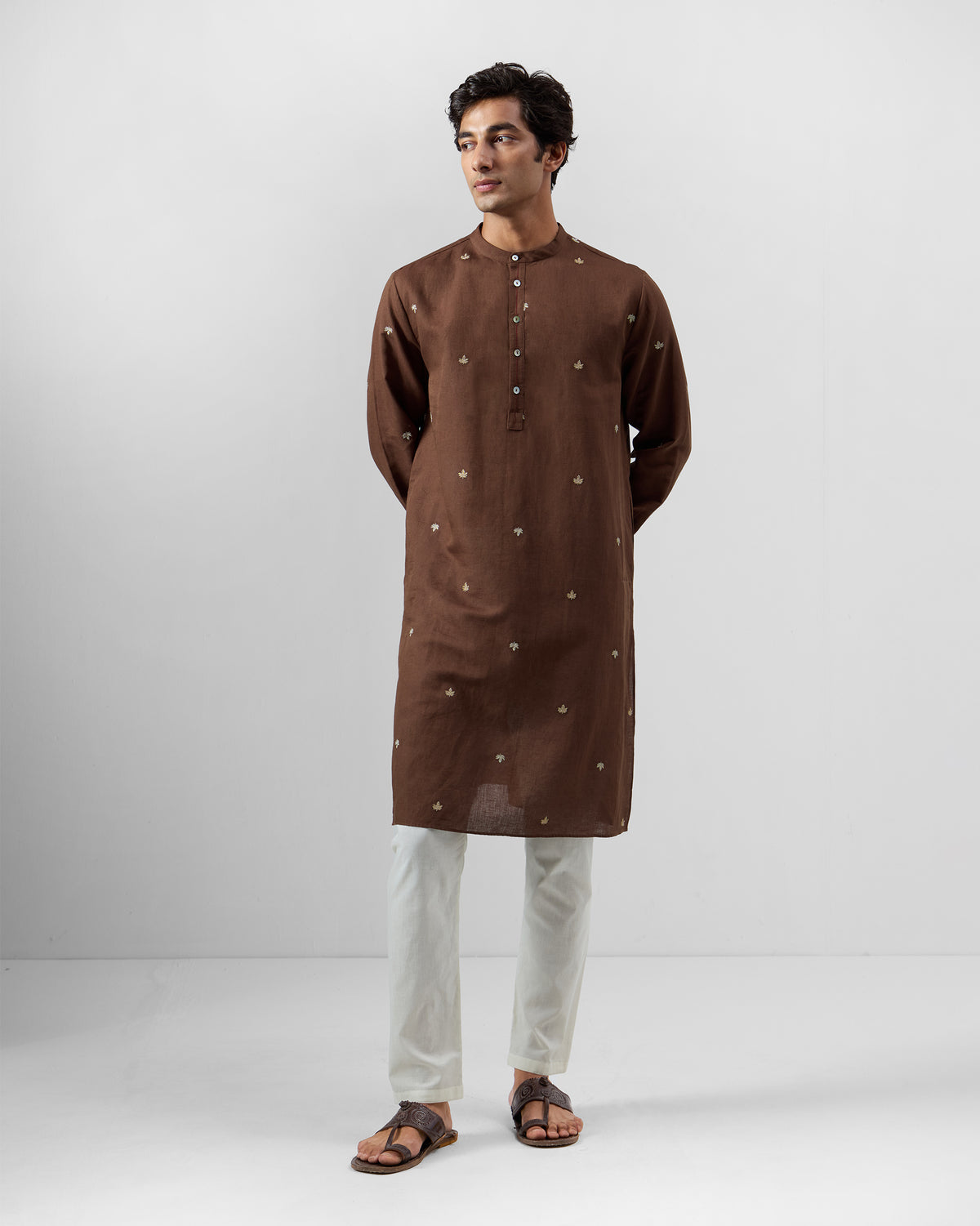 Person wearing a brown Astral kurta with scattered leaf embroidery.