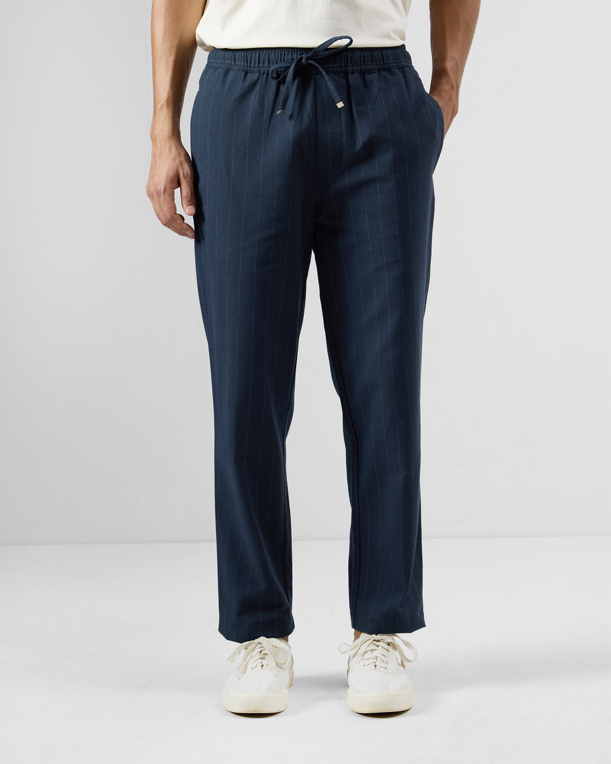 Navy pinstripe Vera trousers with an elastic drawstring waist.