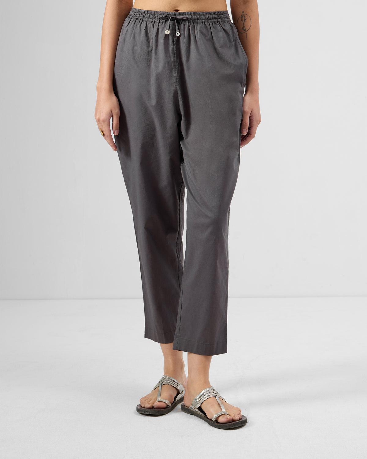 Person wearing charcoal Narrow Pants with a drawstring waist.