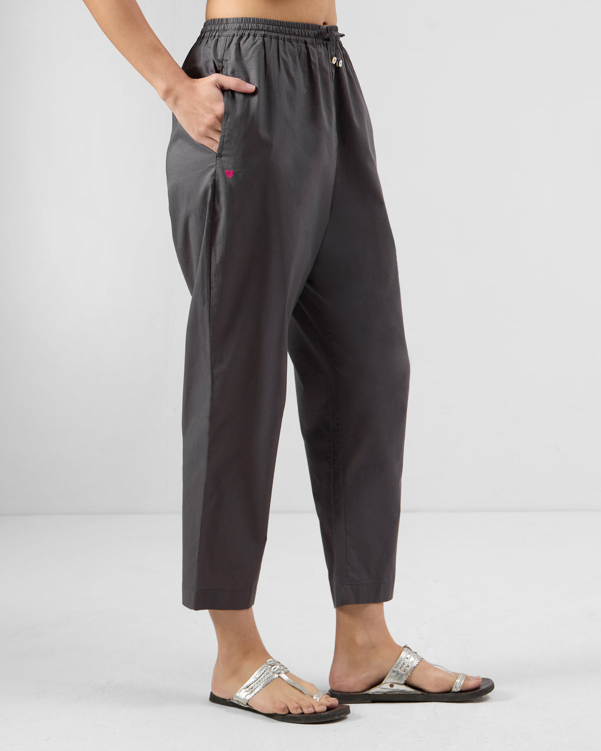 Side view of charcoal Narrow Pants with a tapered cropped hem.