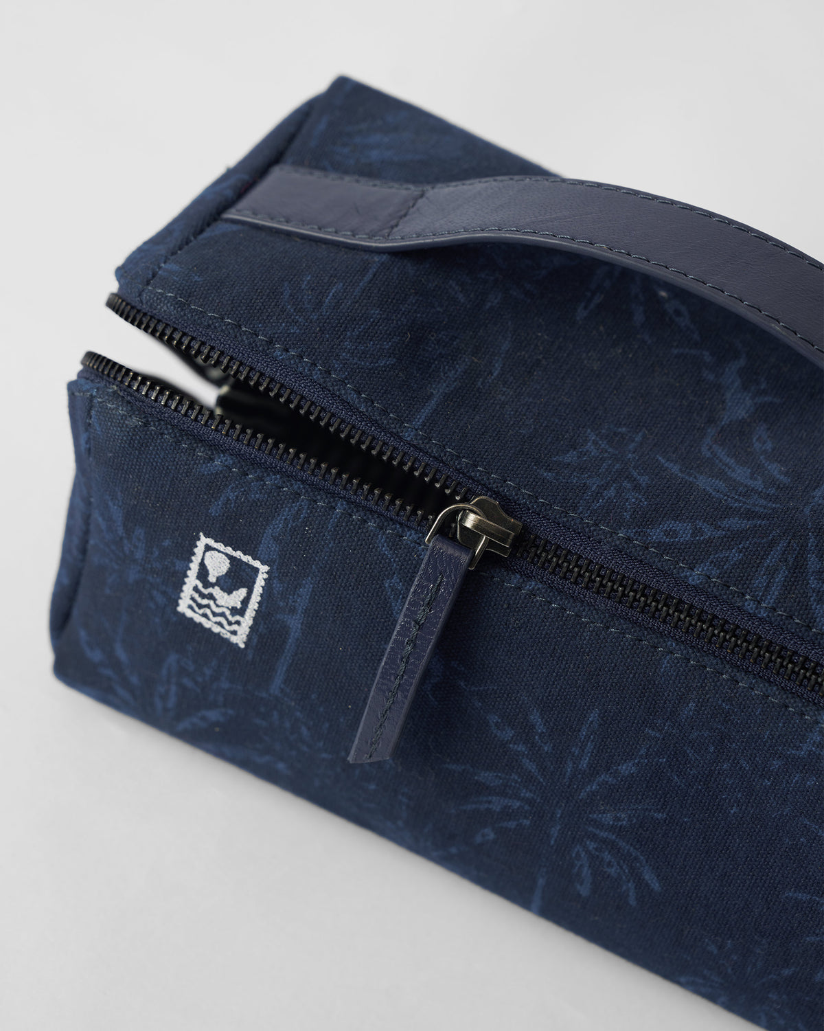 Close-up of a Palm dopp kit showing the zipper and balloon stamp.