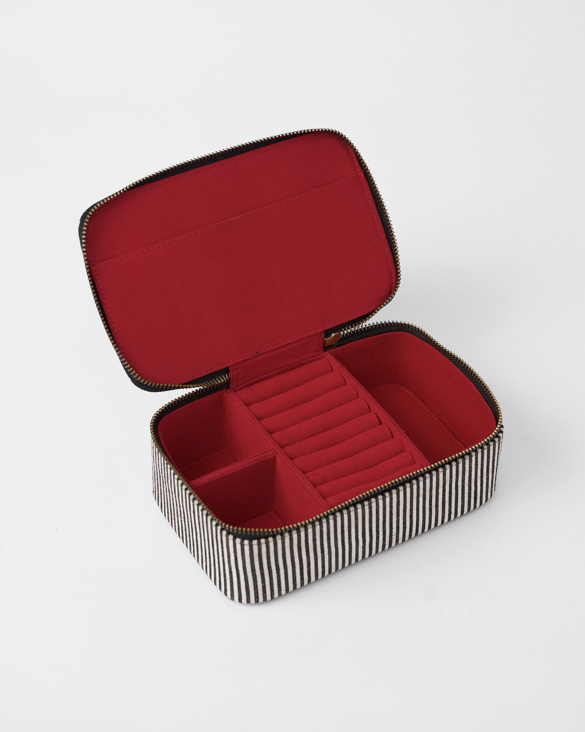 Open Tara jewellery organiser with red lining, ring rolls and compartments.
