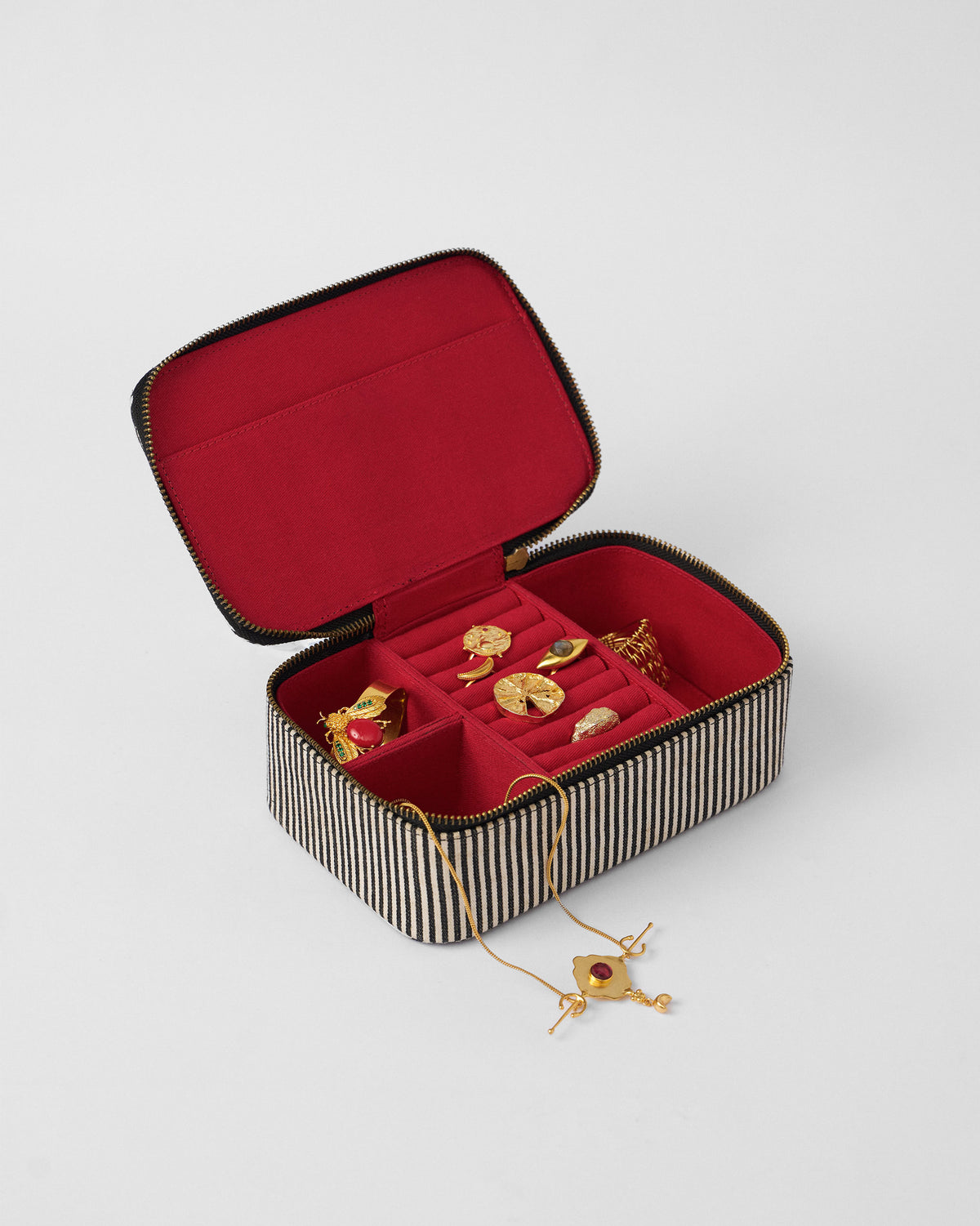 Open Tara jewellery organiser packed with gold jewellery on a red lining.