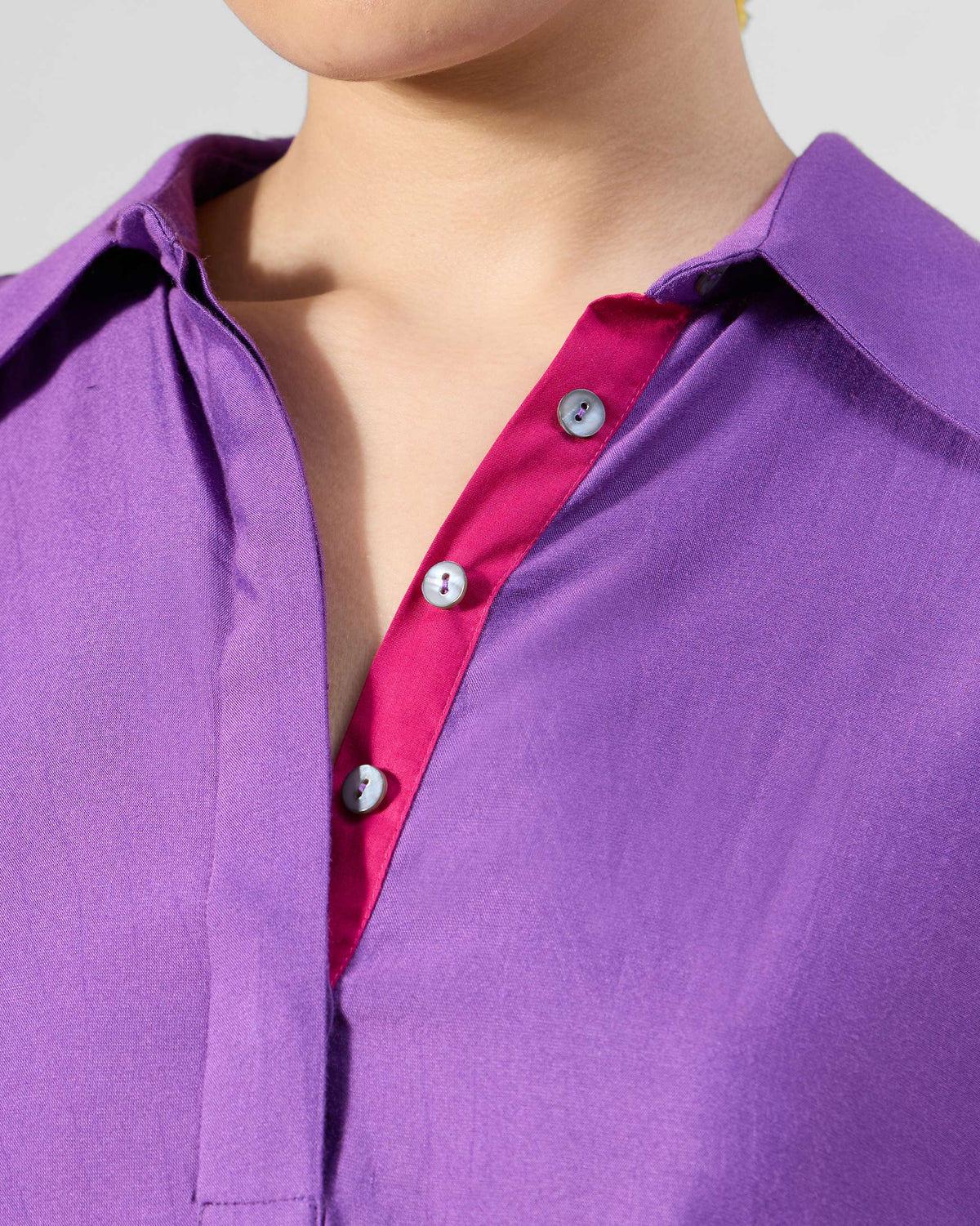 Close-up of a purple Happy Heart Dress collar with a magenta contrast placket.
