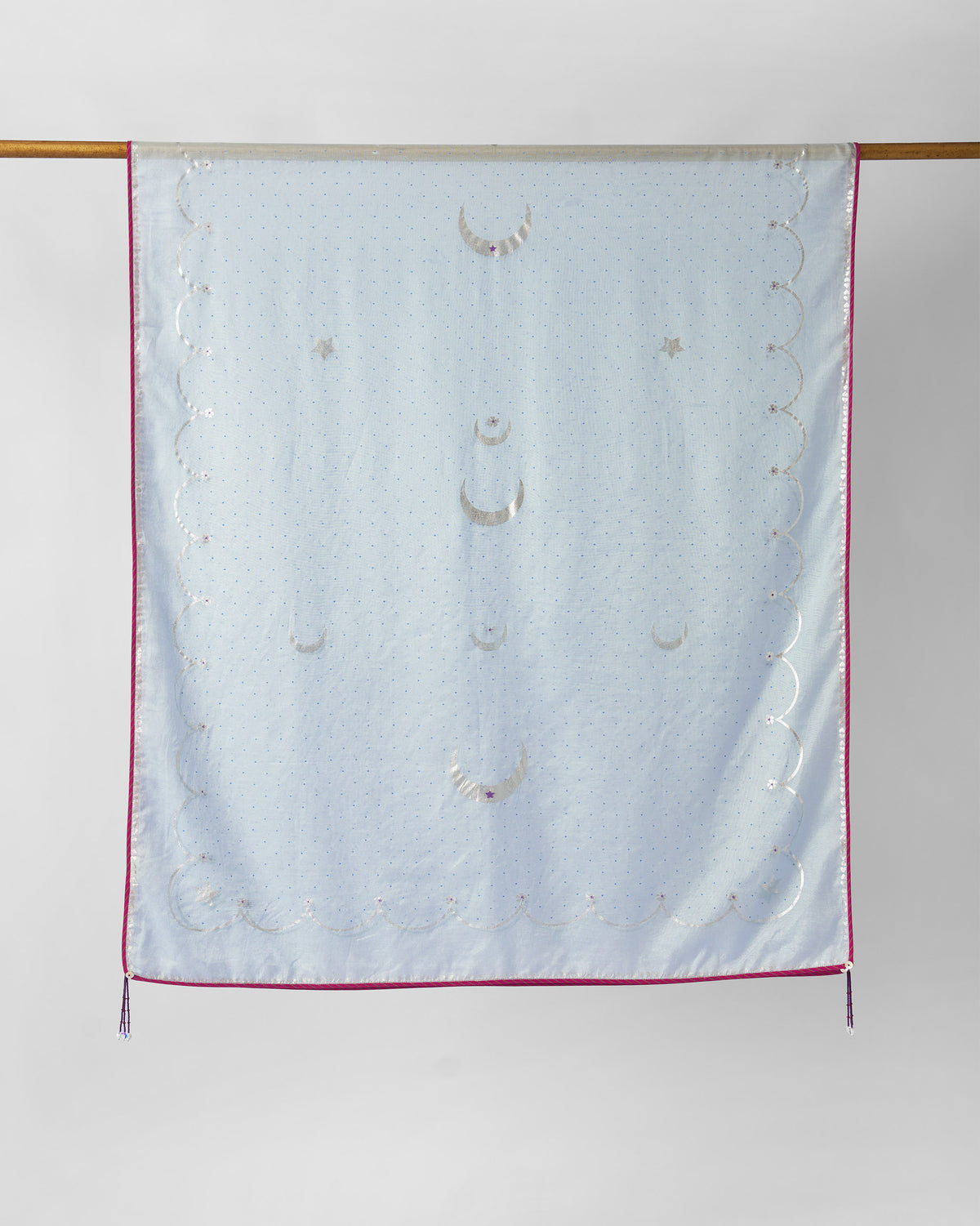 Ice blue Kera Dupatta hung with silver moon and star motifs and pink piping.