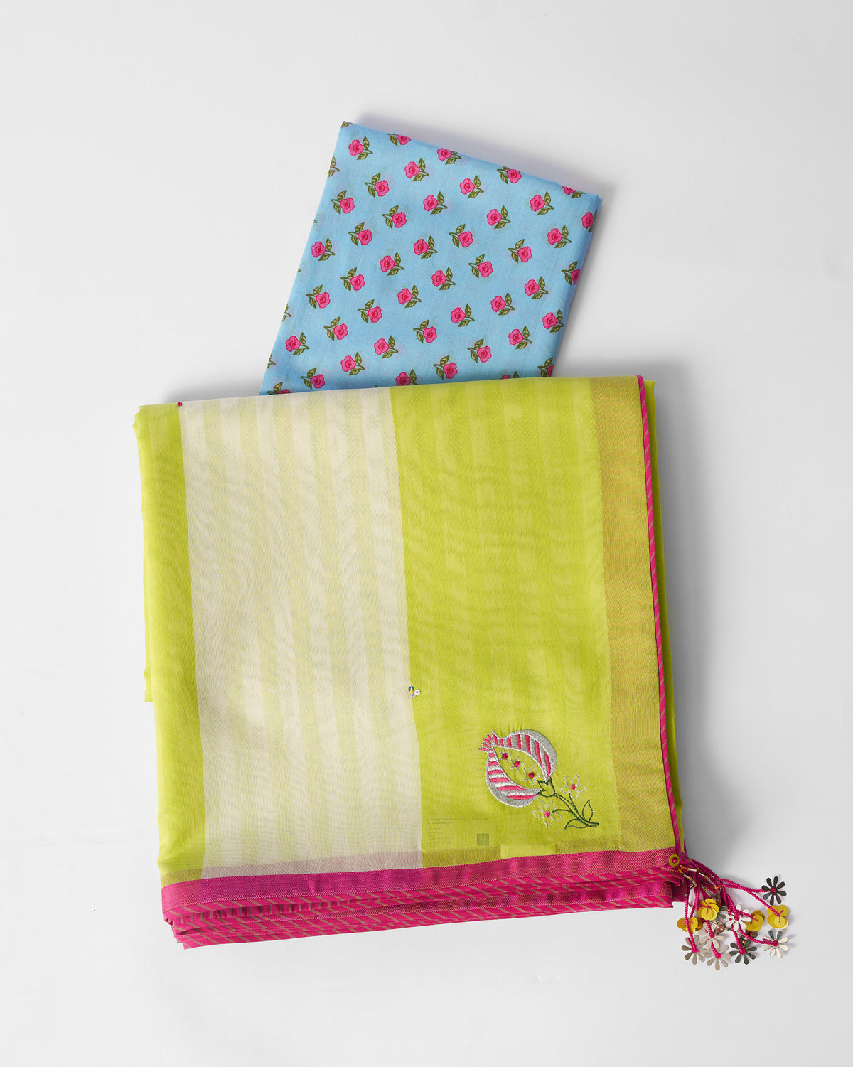 Lime and ivory striped Veha sari laid flat with its blouse piece.