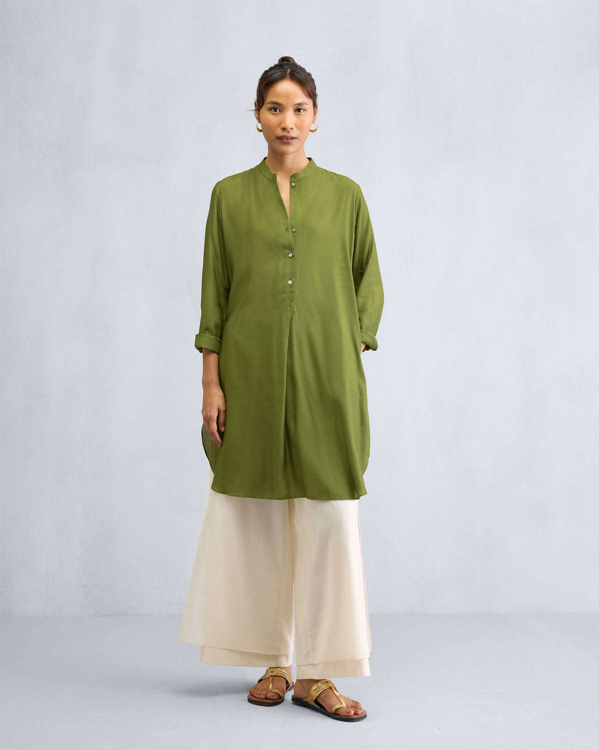 Person wearing an olive mid-length kurta with a mandarin collar.