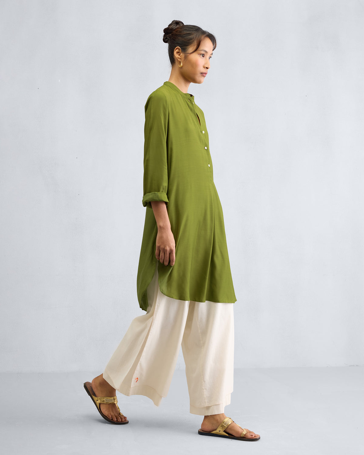 Side view of an olive mid-length kurta with side slits.