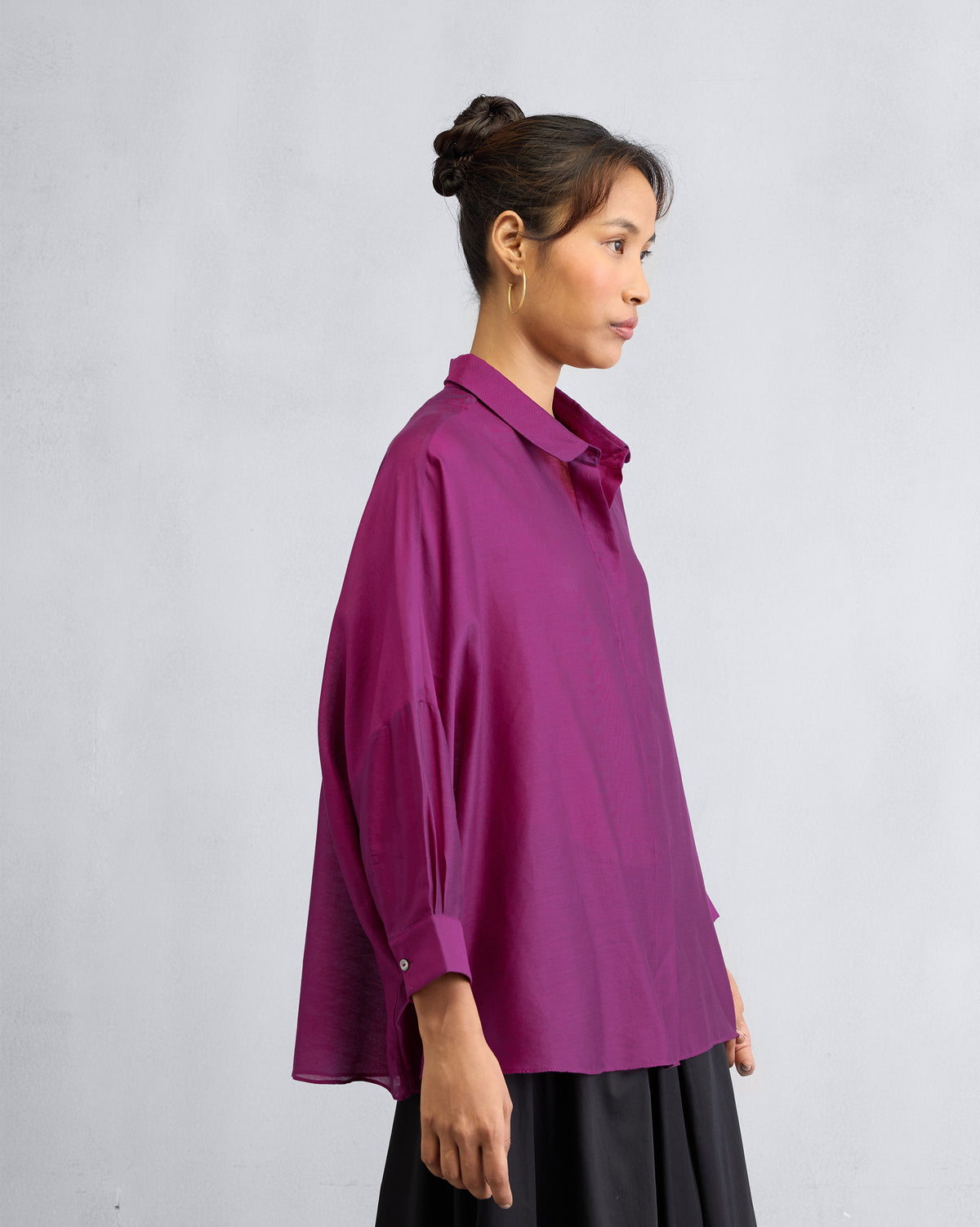 Side view of a mulberry boxy shirt showing the loose silhouette and side slit.