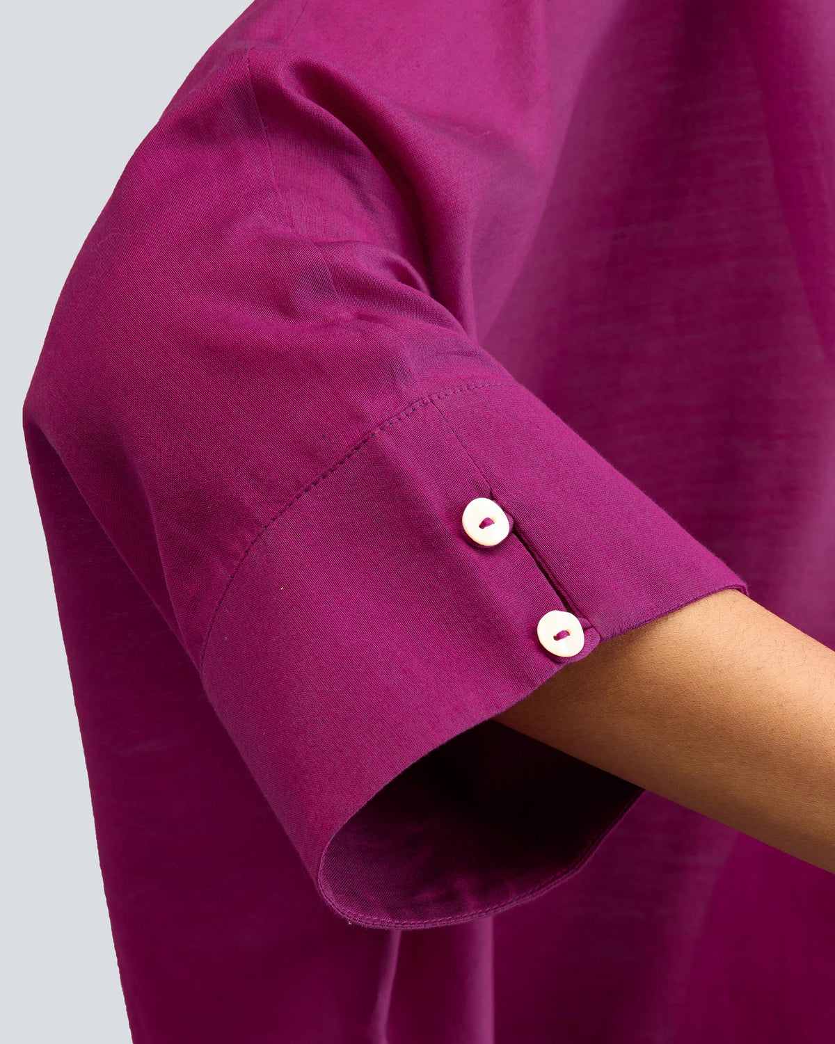Close-up of the mulberry Hala tunic sleeve cuff with two white buttons.