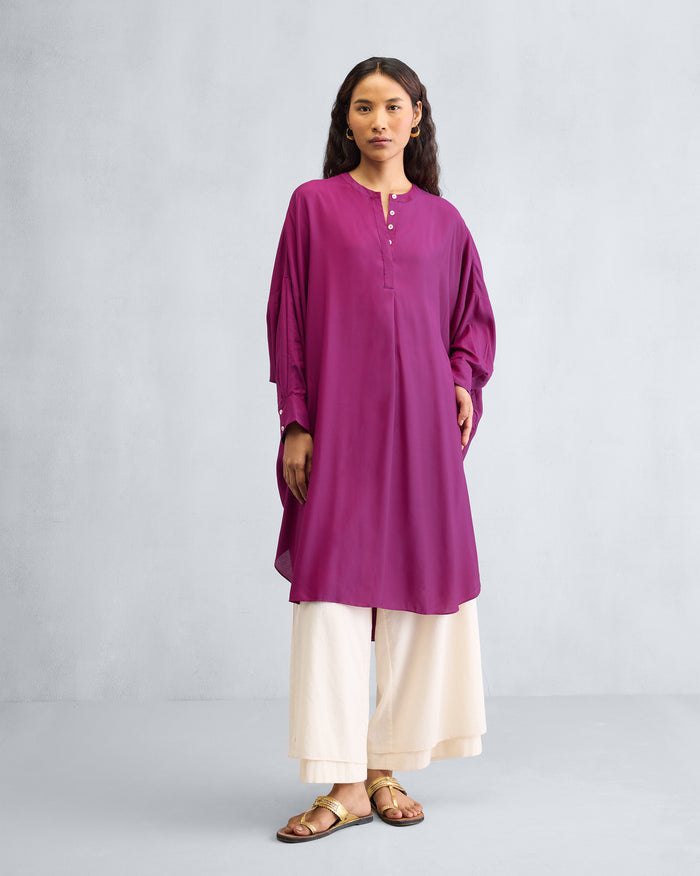 Person wearing a mulberry Lazy Sunday tunic with a mandarin collar.