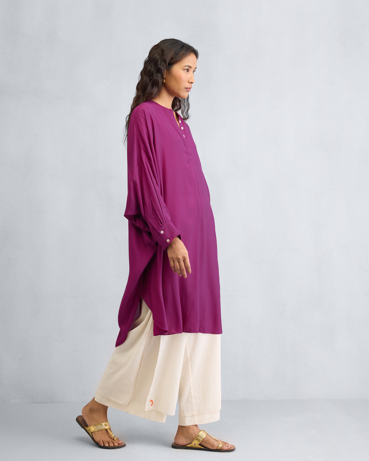 Side view of a mulberry Lazy Sunday tunic showing side slits and balloon sleeves.