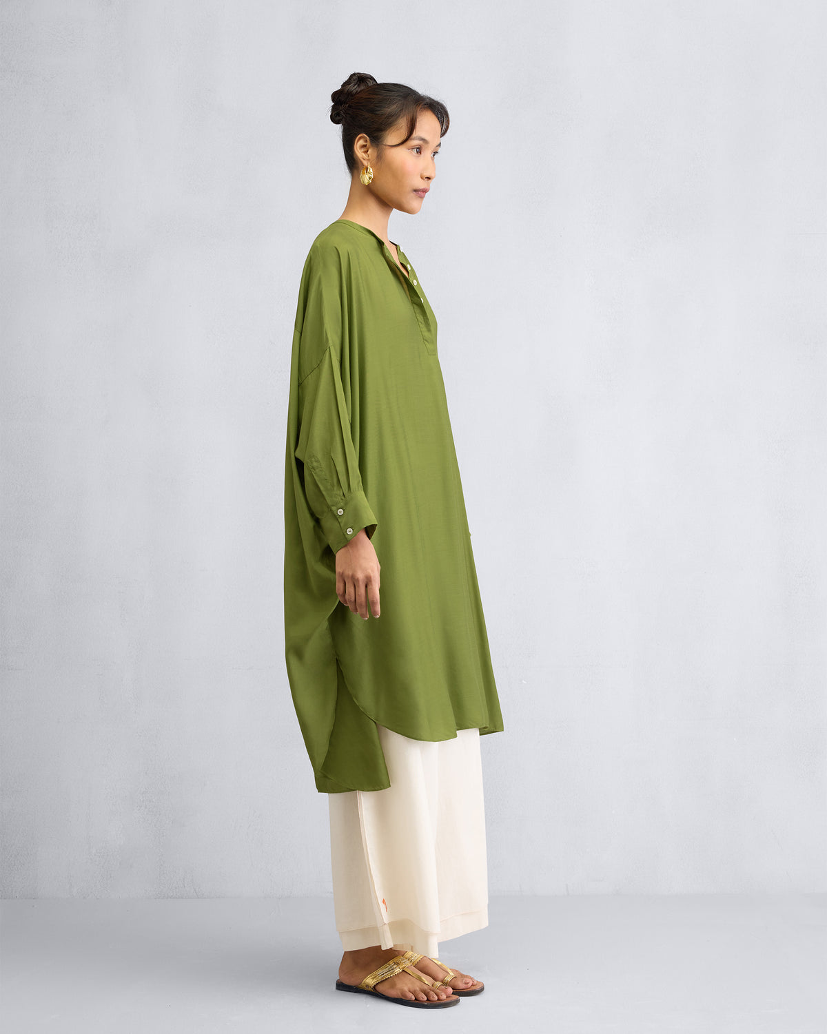 Side view of an olive Lazy Sunday tunic with a high-low hem.