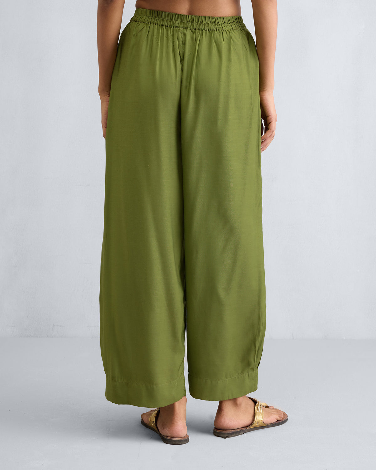 Back of olive Serene pants with an elastic waistband and wide legs.