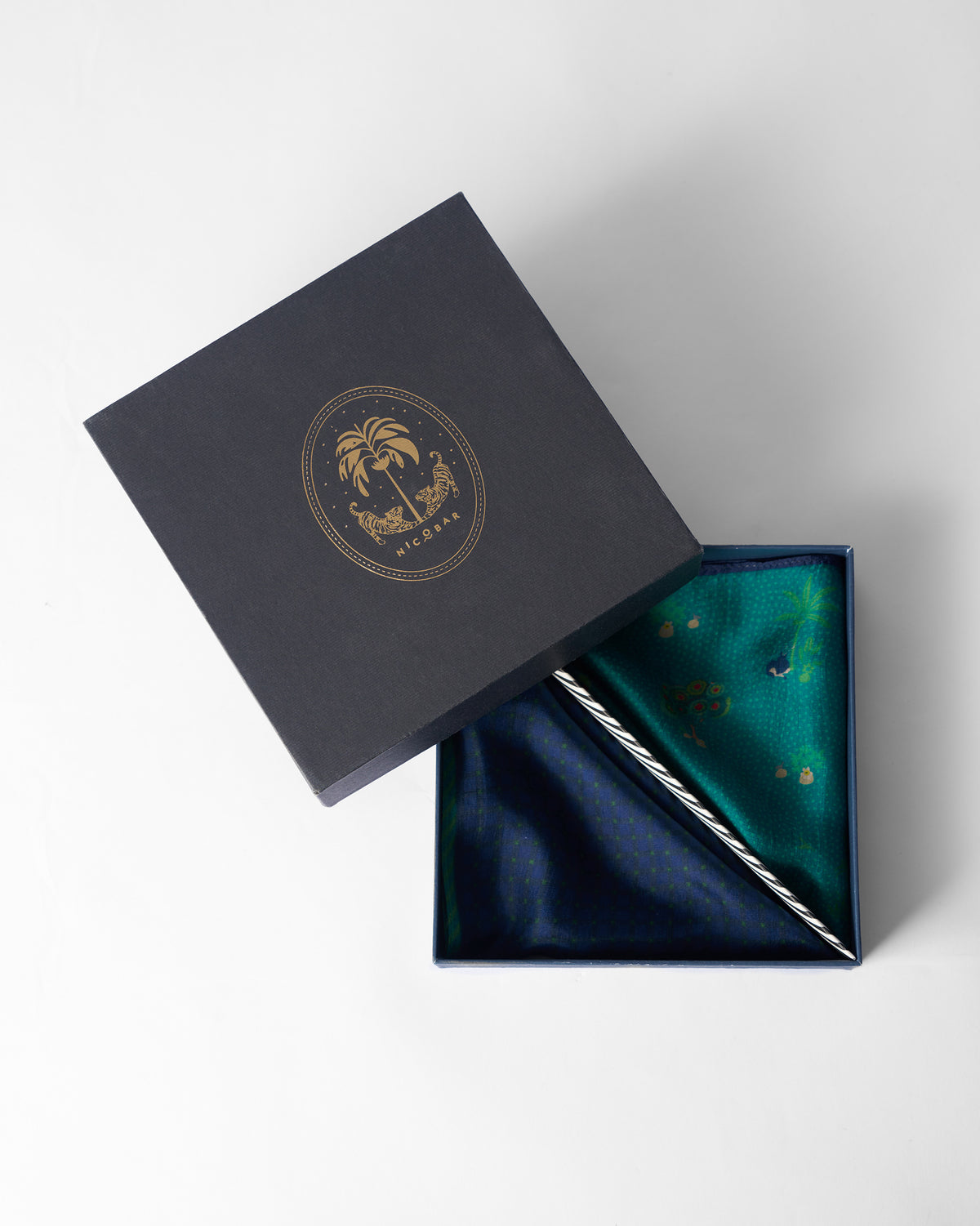 Firefly Pocket Squares in a navy Nicobar gift box.