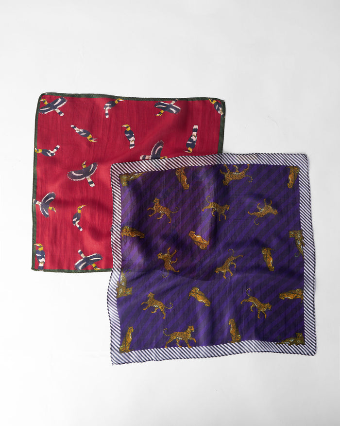 Pair of purple and crimson Leopard Pocket Squares laid flat.
