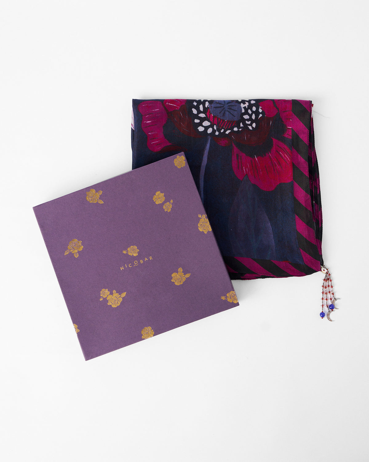 Garden Muse Scarf folded beside a purple gift box.