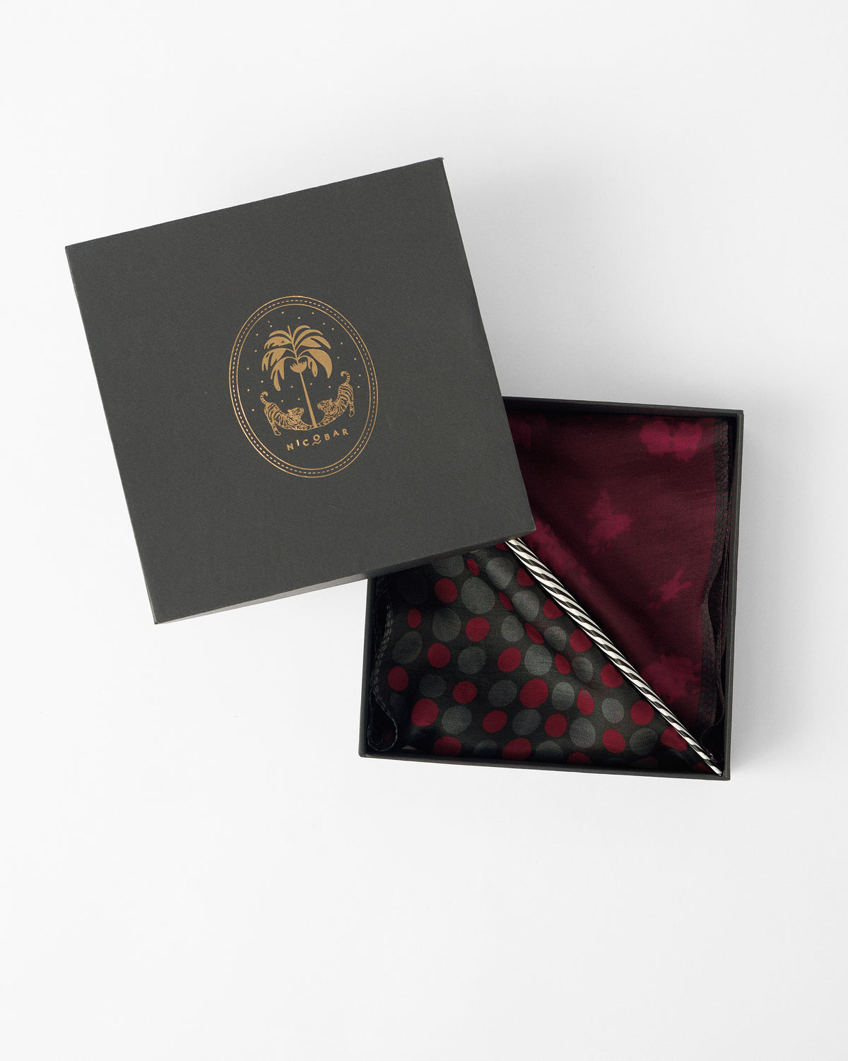 Scarlet Bloom pocket squares folded in an open black Nicobar gift box.