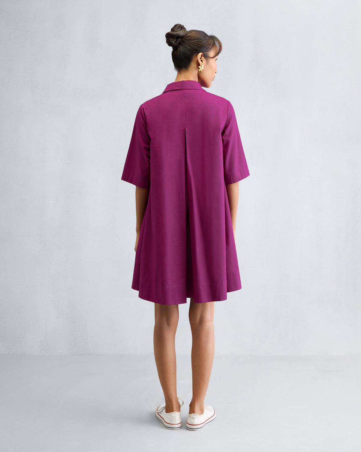 Back of a mulberry A-line Short Dress with a center box pleat.