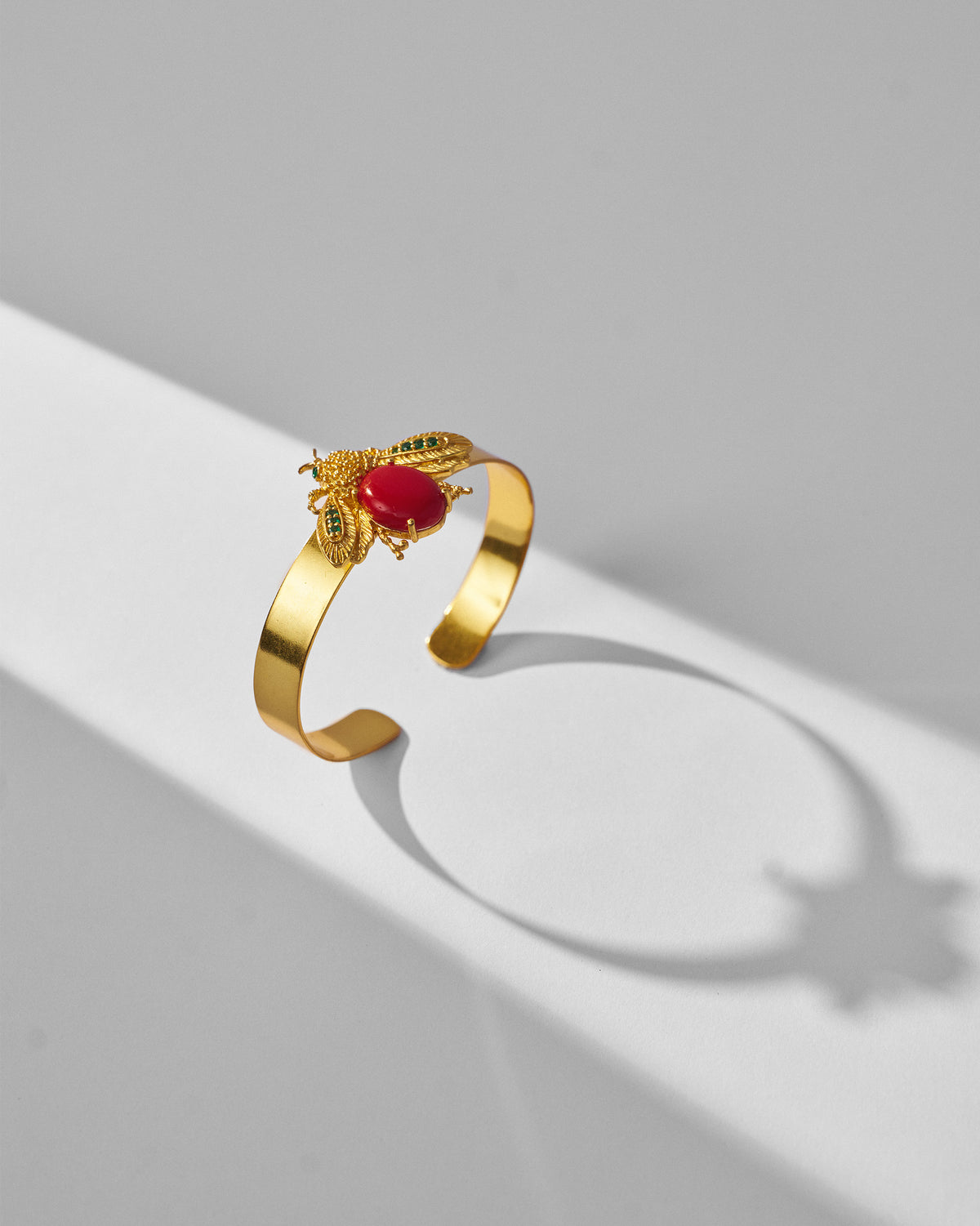 Gold Bug open cuff with a red stone insect and green wing stones.