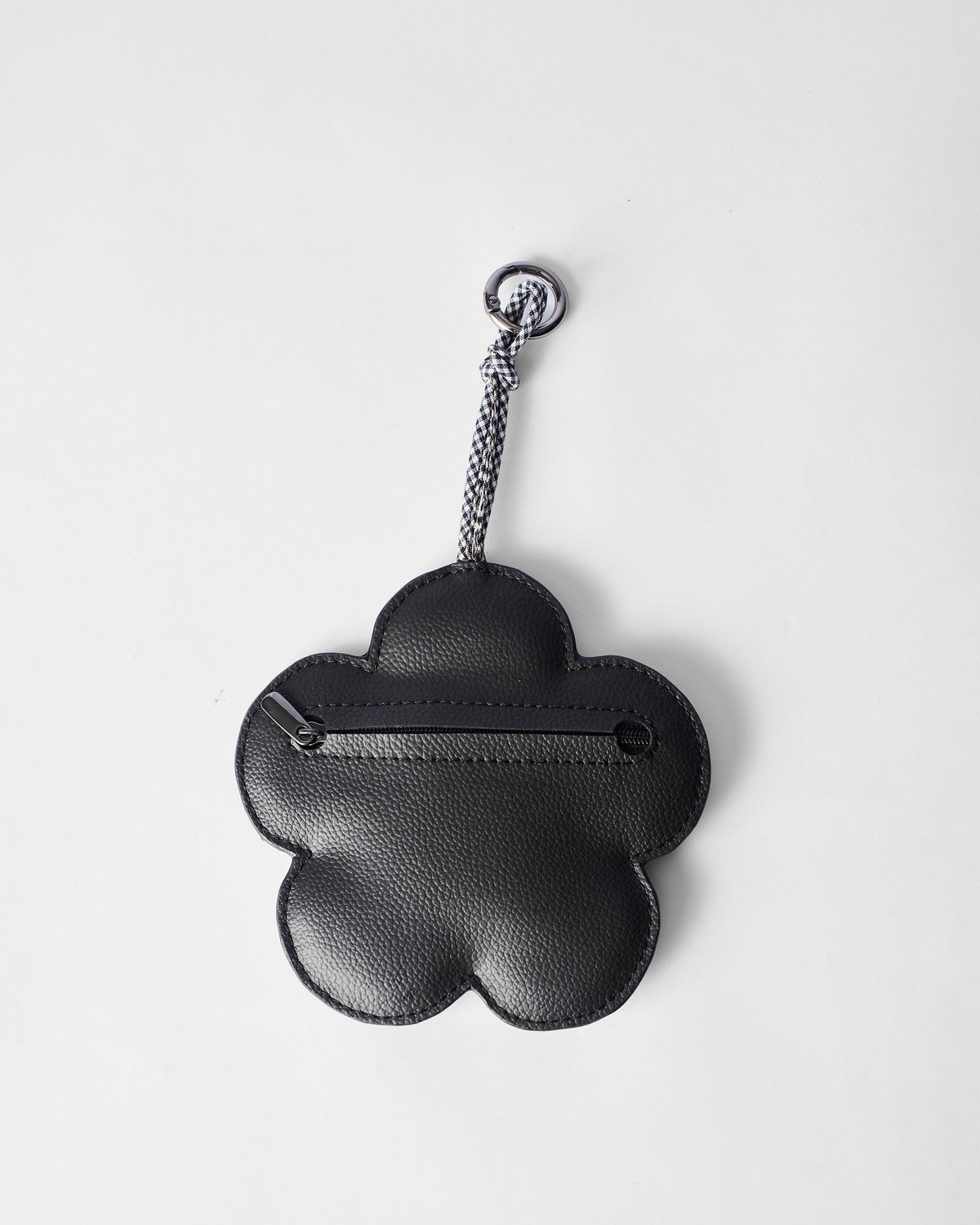 Back of a black Flower Coin Pouch showing its zip closure.