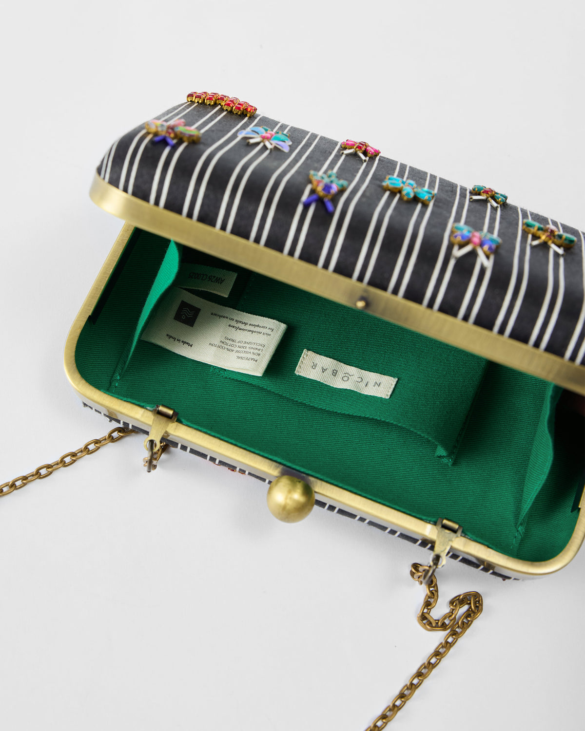 Open Martini Clutch showing green lining and beaded bugs.