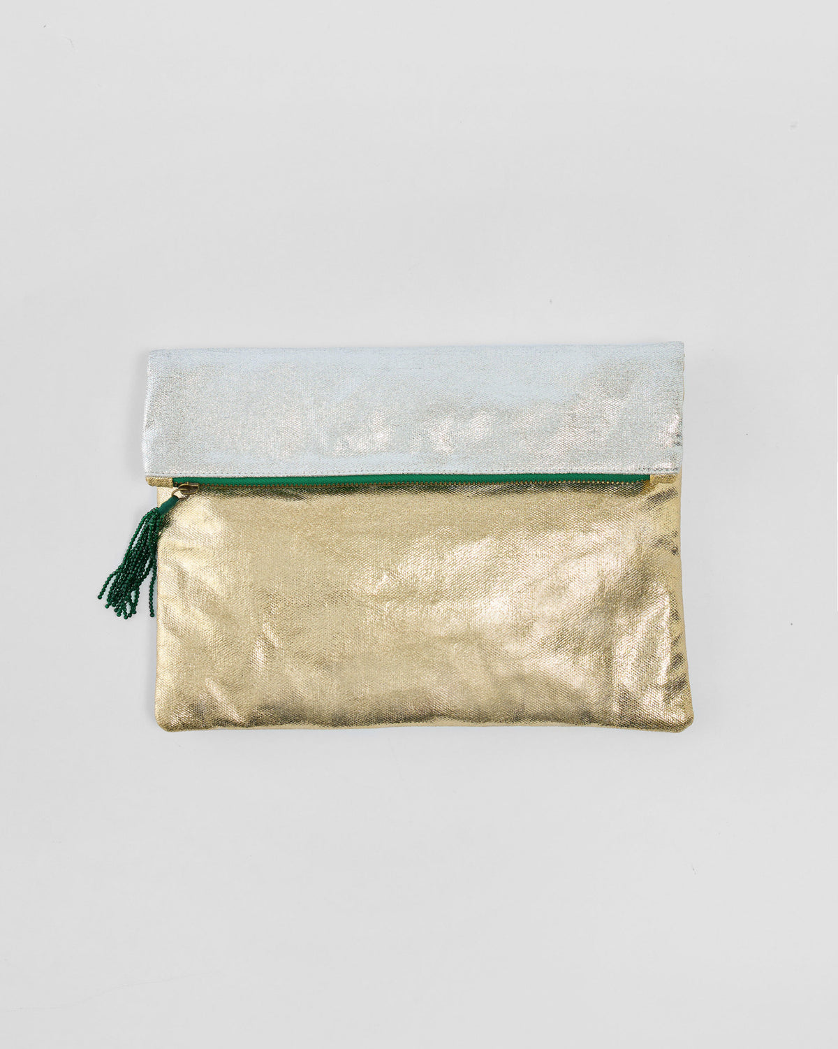 Gold and silver Fold Over Clutch with a green zipper tassel.