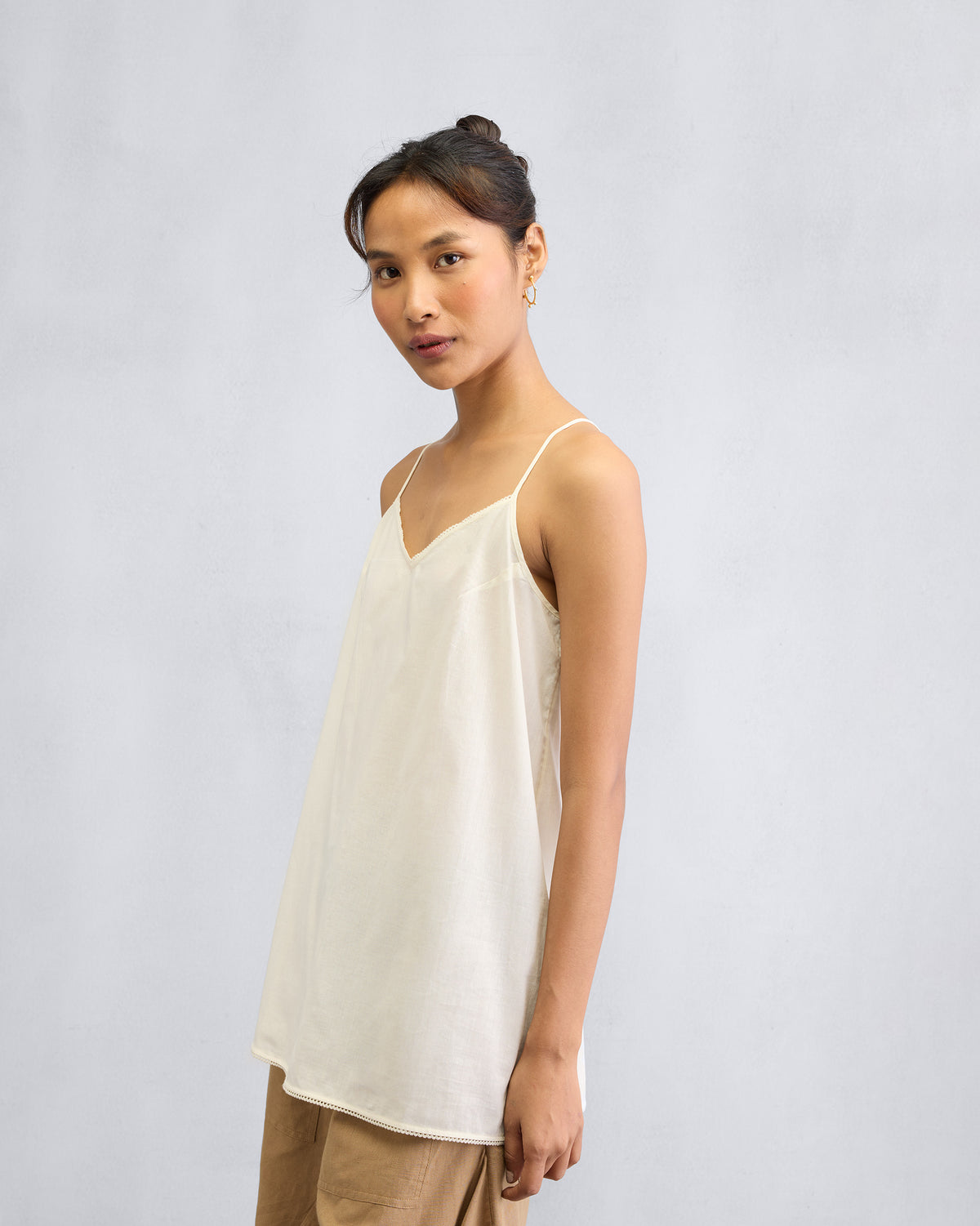 Ivory Afra Camisole with lace trim worn at a three-quarter angle.