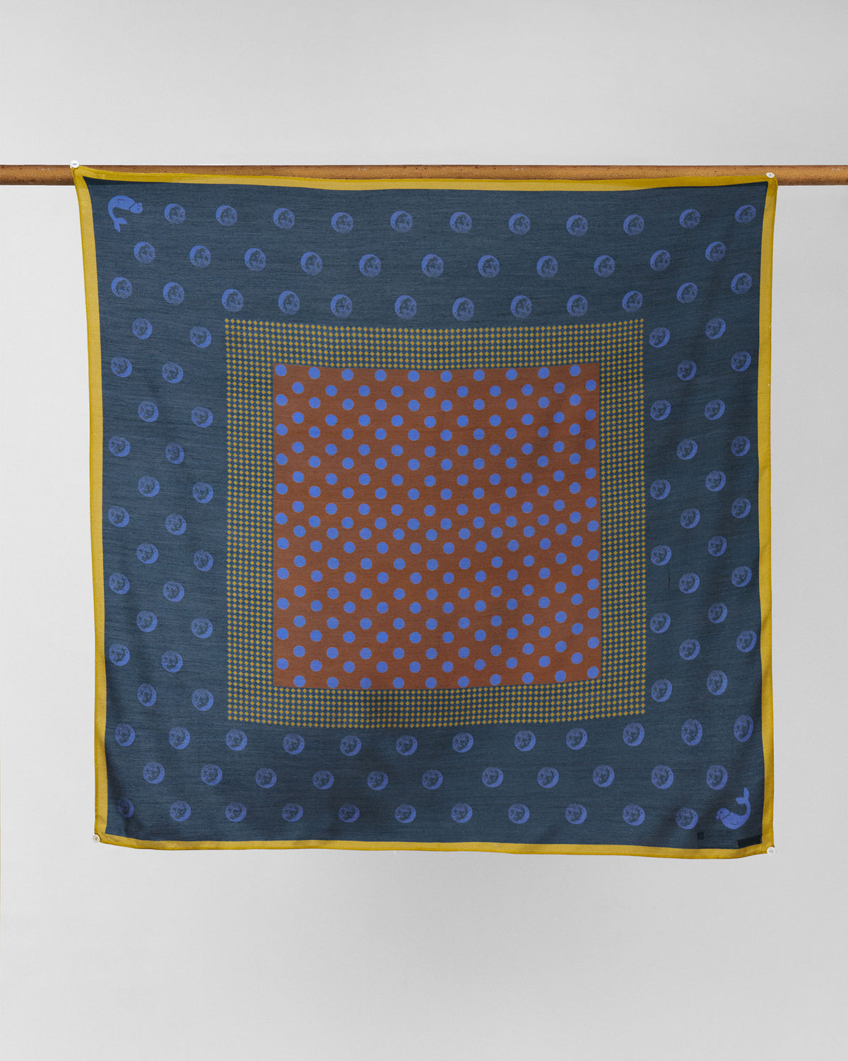 Rhythm Scarf in navy with a rust centre panel and yellow border.
