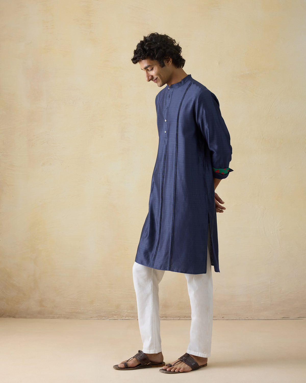 Side view of a navy Naaz kurta with front tucks.
