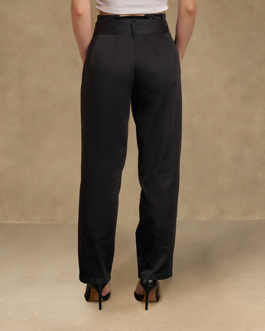 Back view of the Gumdrop Pants, the black cotton satin falling in a clean, narrow line.