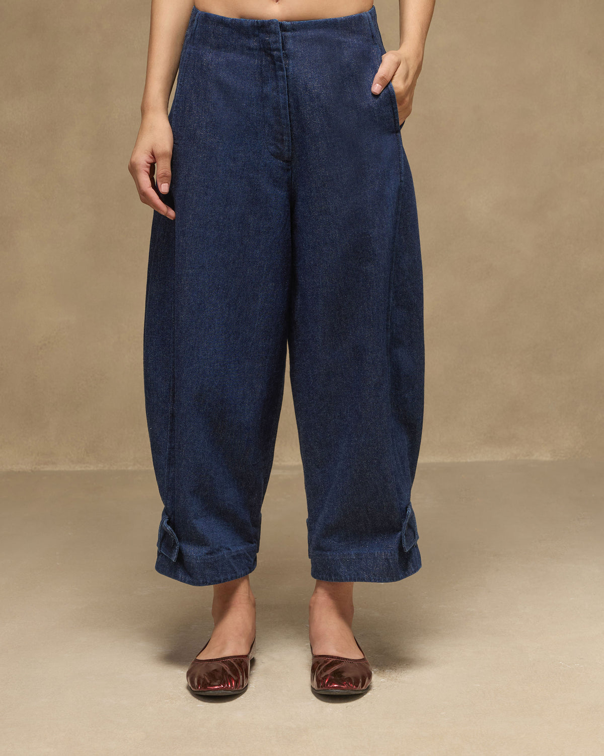 Navy Groove Pants with a relaxed denim fit and tapered button-tab hems.