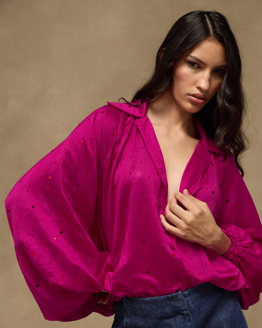 The fuchsia Cloud Overlay up close, sequins catching the light across the cotton silk sleeve.