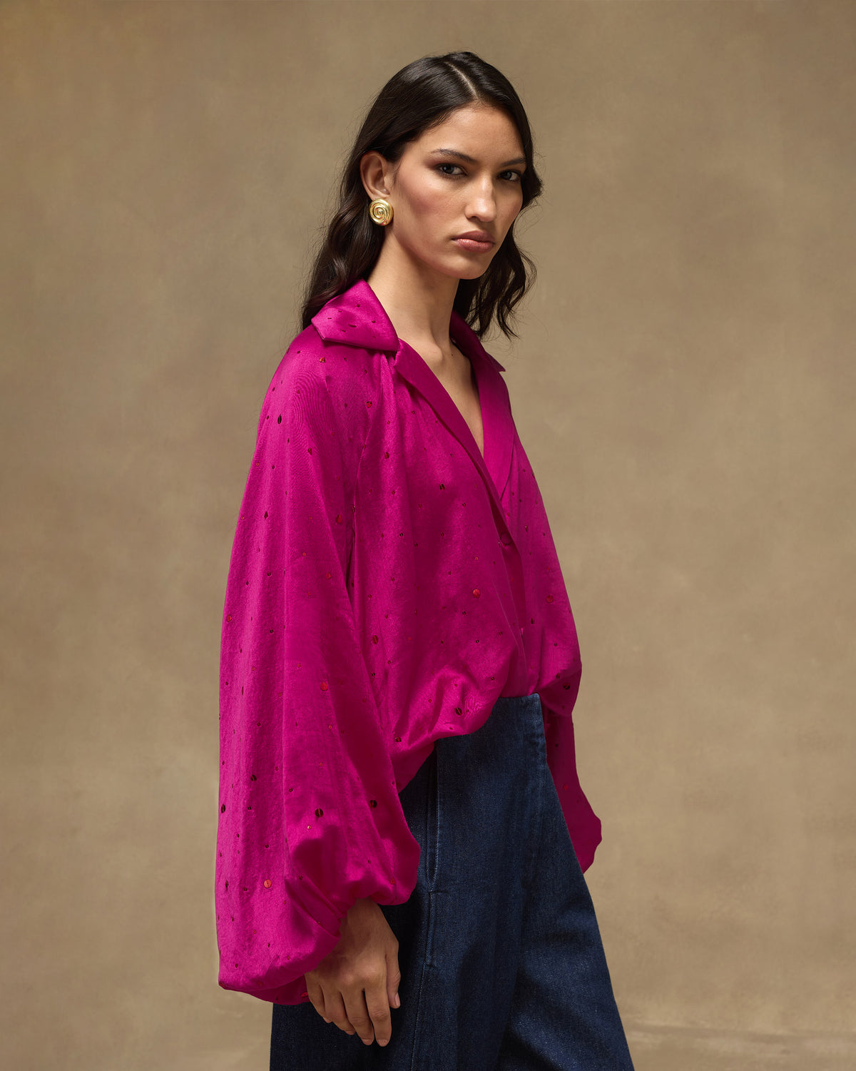 Fuchsia Cloud Overlay with balloon sleeves tucked into dark trousers.