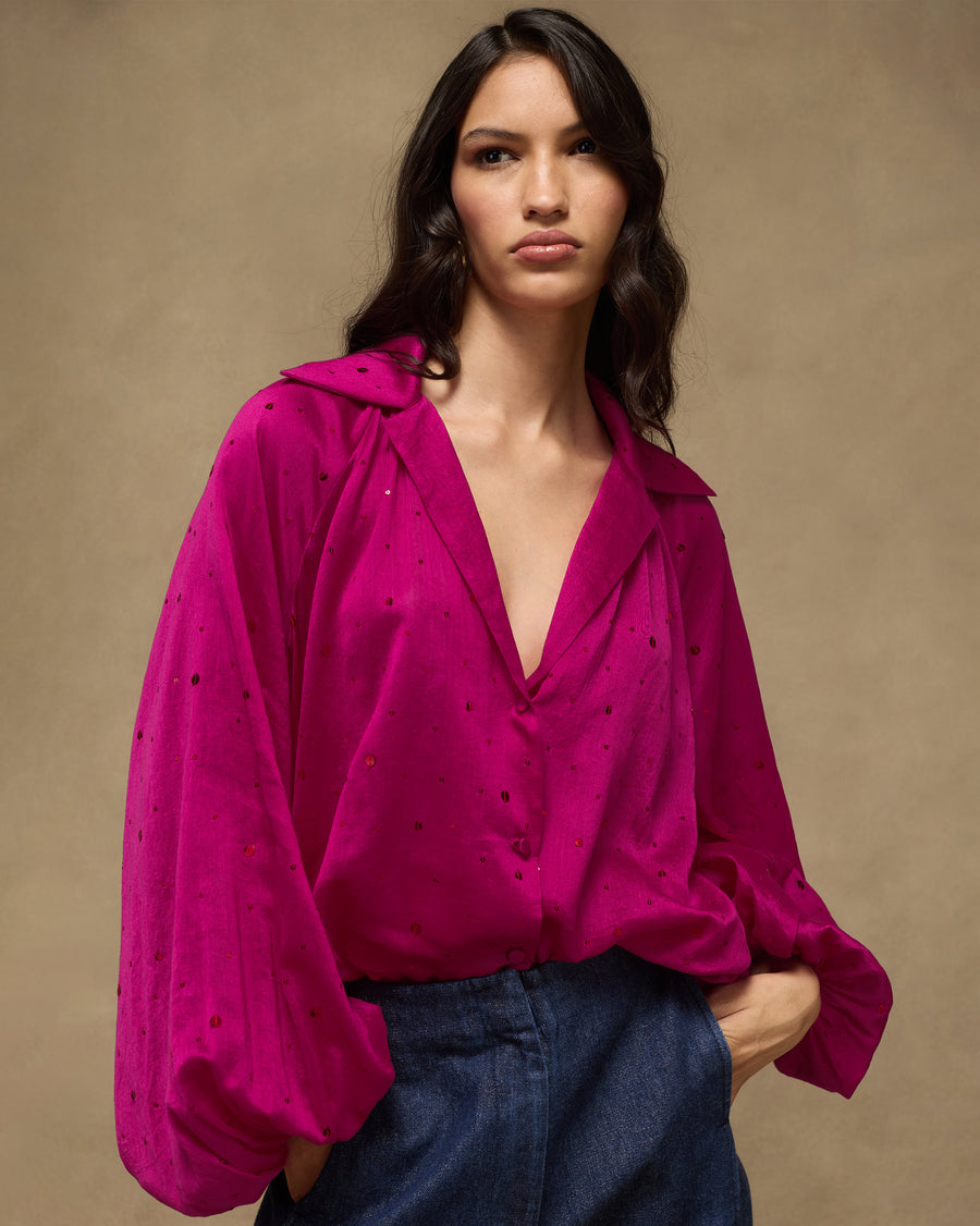 The Cloud Overlay in fuchsia, front view: a loose cotton silk shirt-overlay with sequin embroidery and balloon sleeves, worn with dark denim.
