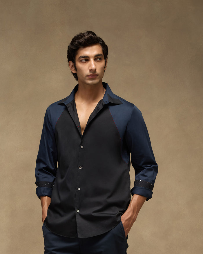 Person wearing a black-and-navy Moonrise shirt with colour-blocked panels.