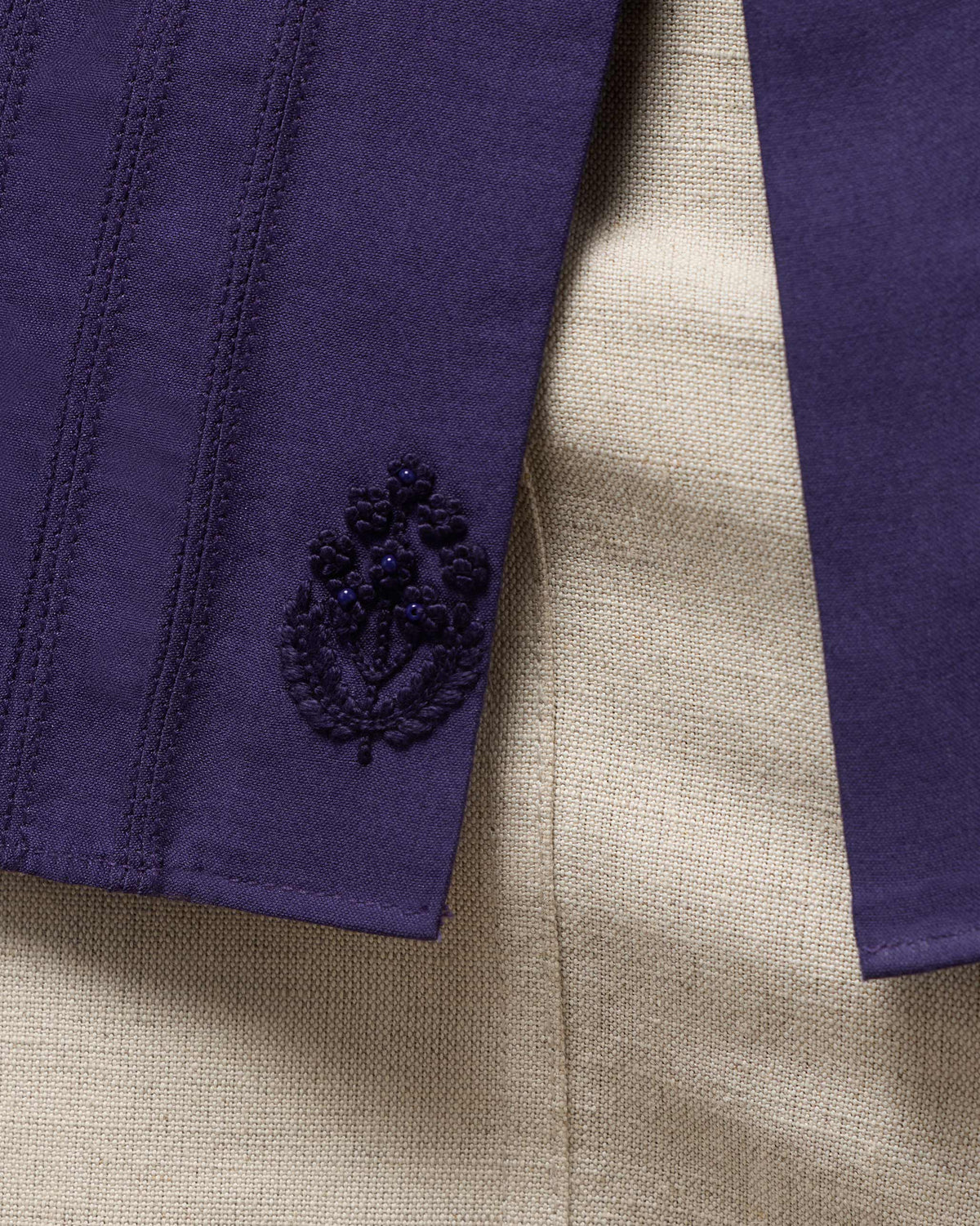 Close-up of Sundown Shirt hem with tonal floral embroidery and side slit.
