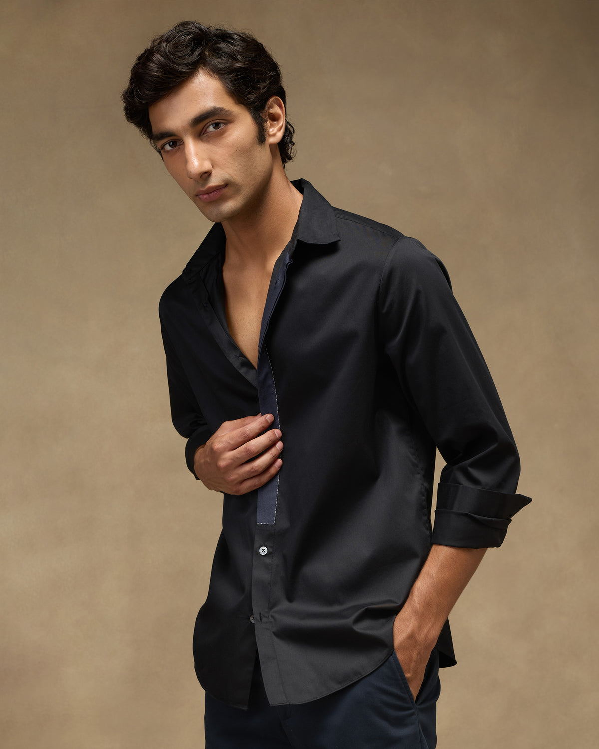 Person wearing a black Midnight Shirt with contrast placket trim.