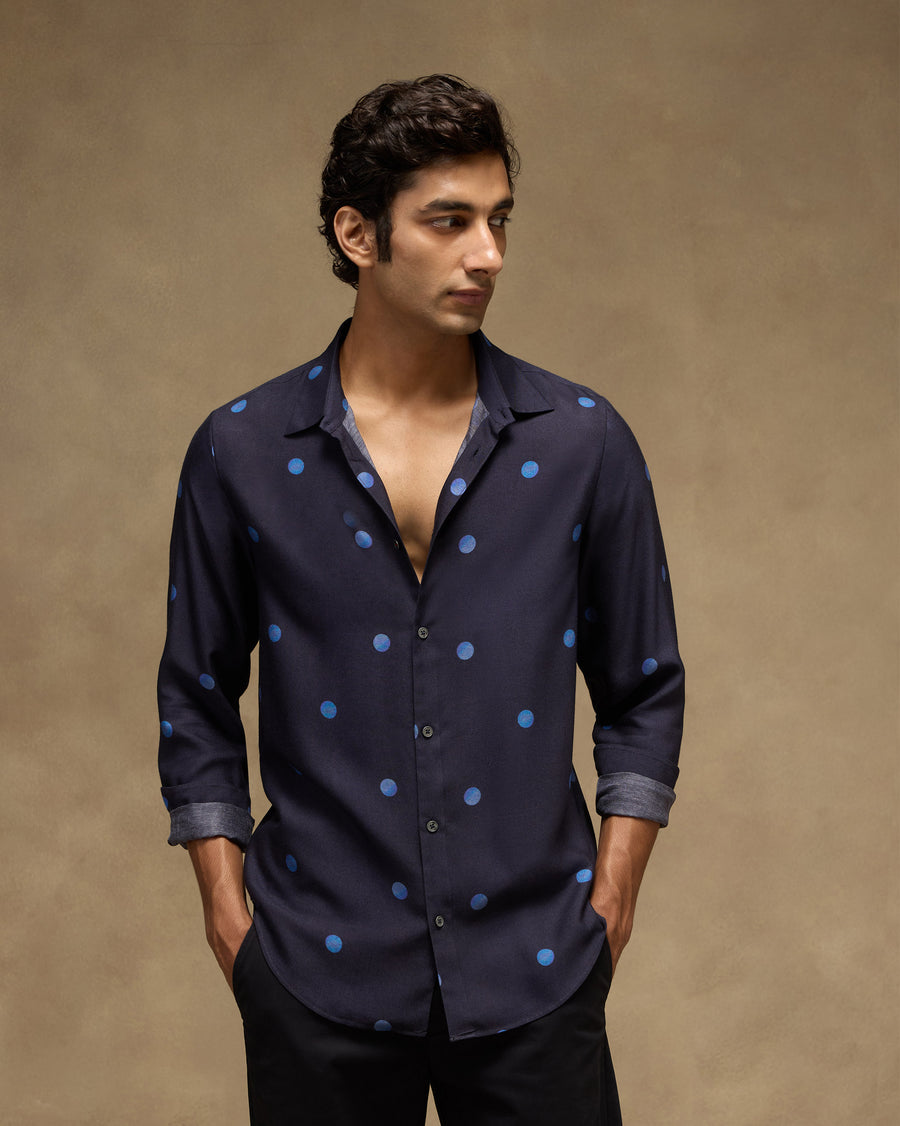 The Daze Shirt, front view: a deep navy viscose silk shirt with tonal blue polka dots, worn with black trousers.
