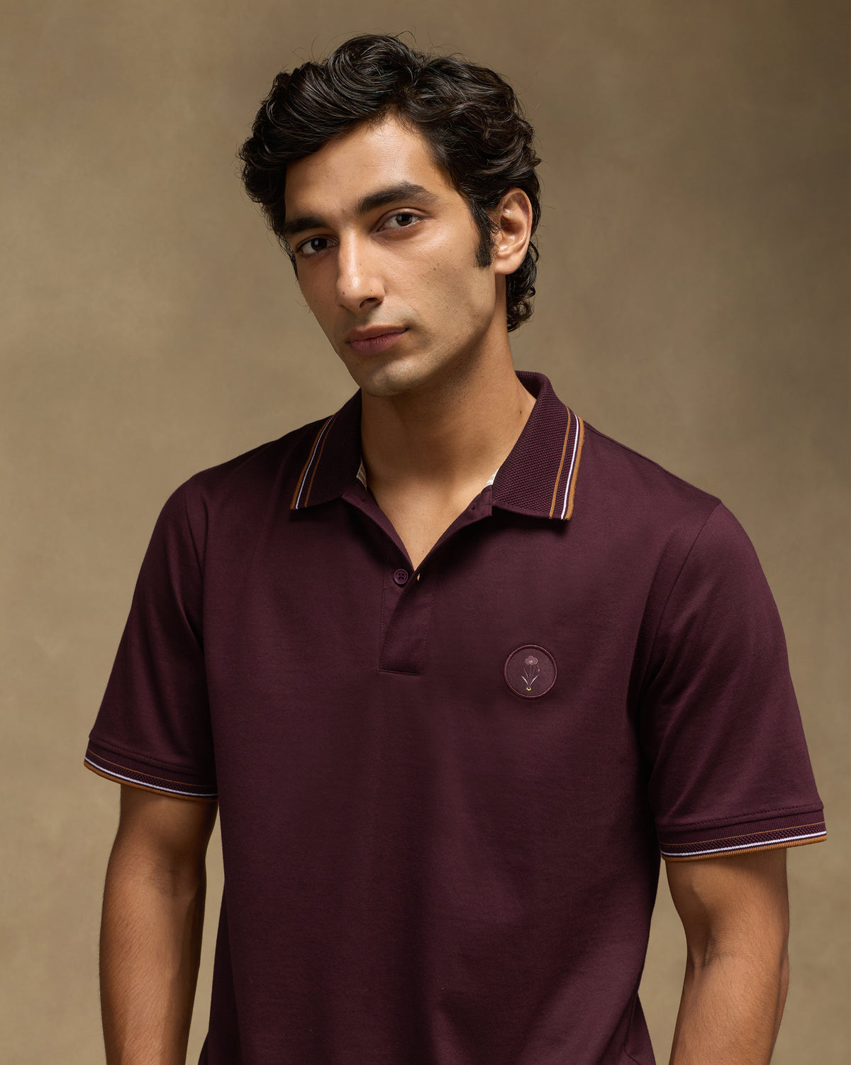 Maroon Stag Polo showing striped collar tipping and a chest crest.