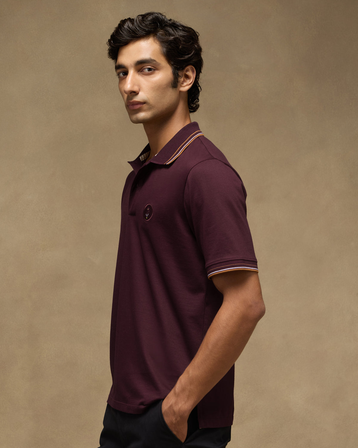 Side view of a maroon Stag Polo with striped cuff tipping.